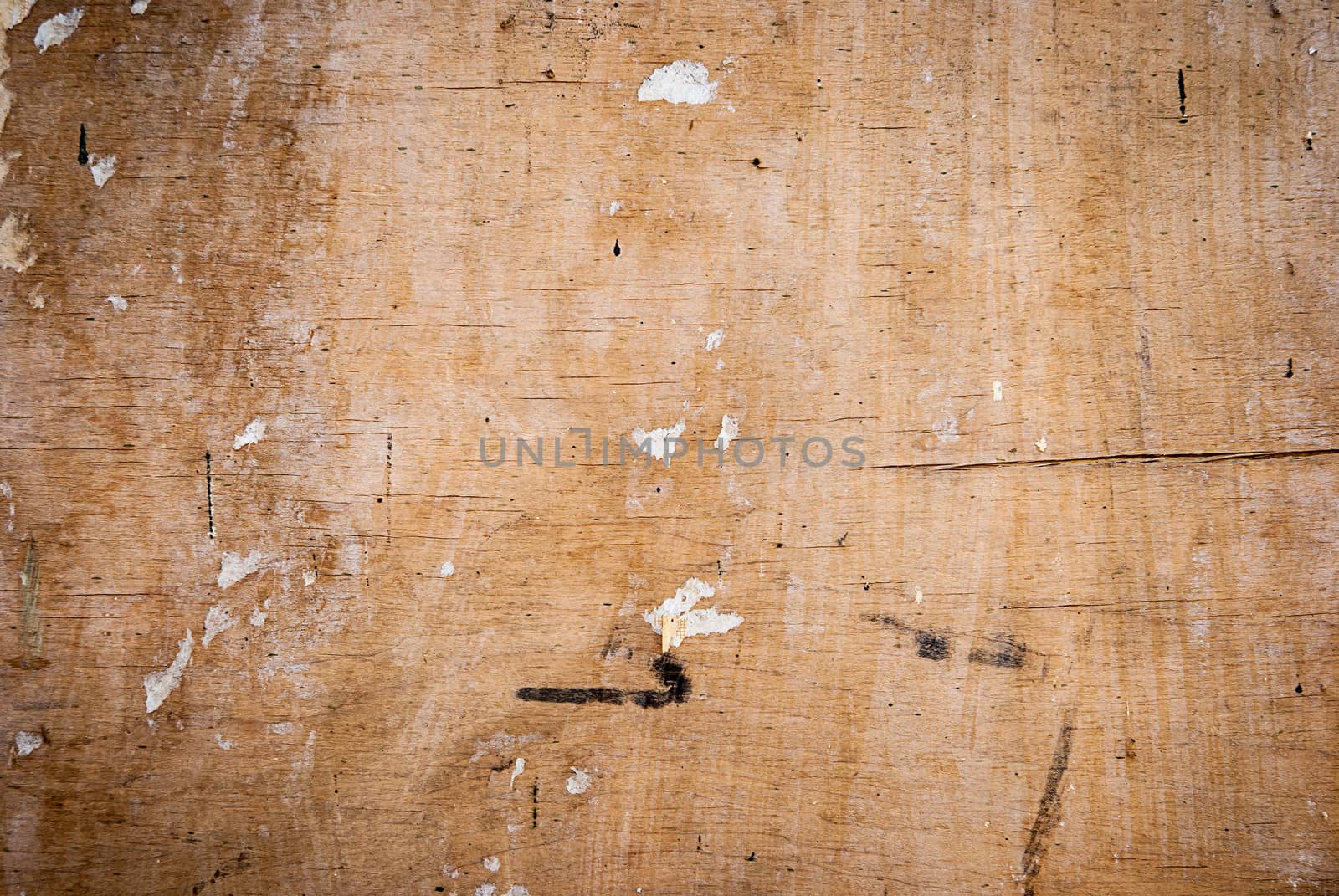 texture of old wood with cracks and the remnants of the old paper