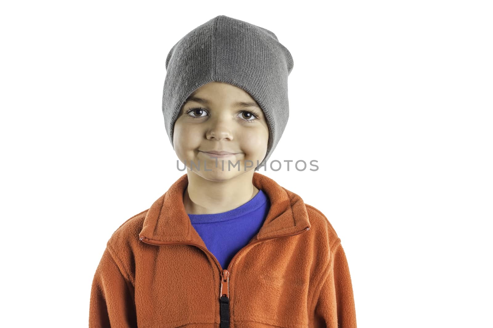 A young boy dressed in winter clothing isolated on a white background.