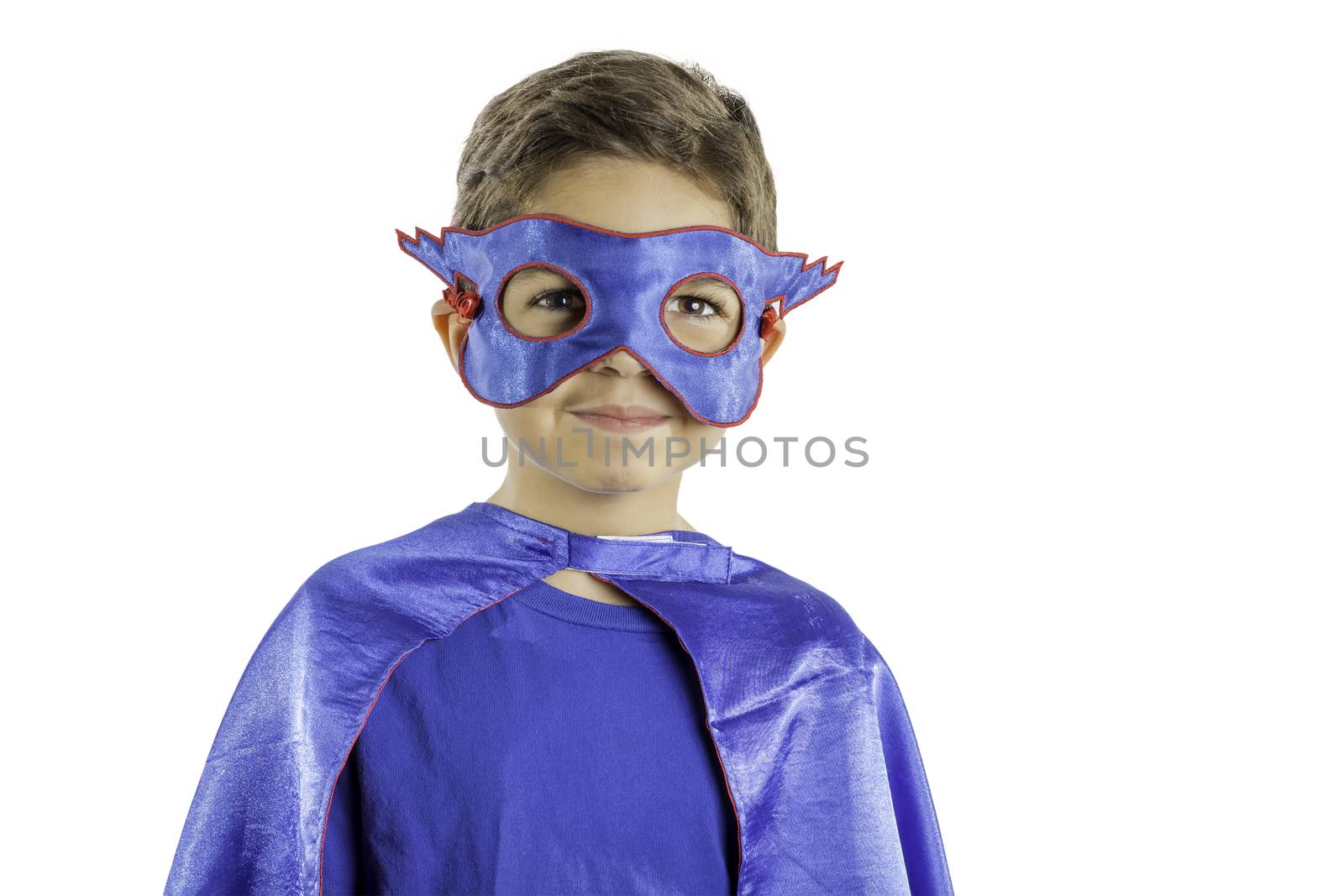 A young boy dressed in a superhero costume isolated on a white background.