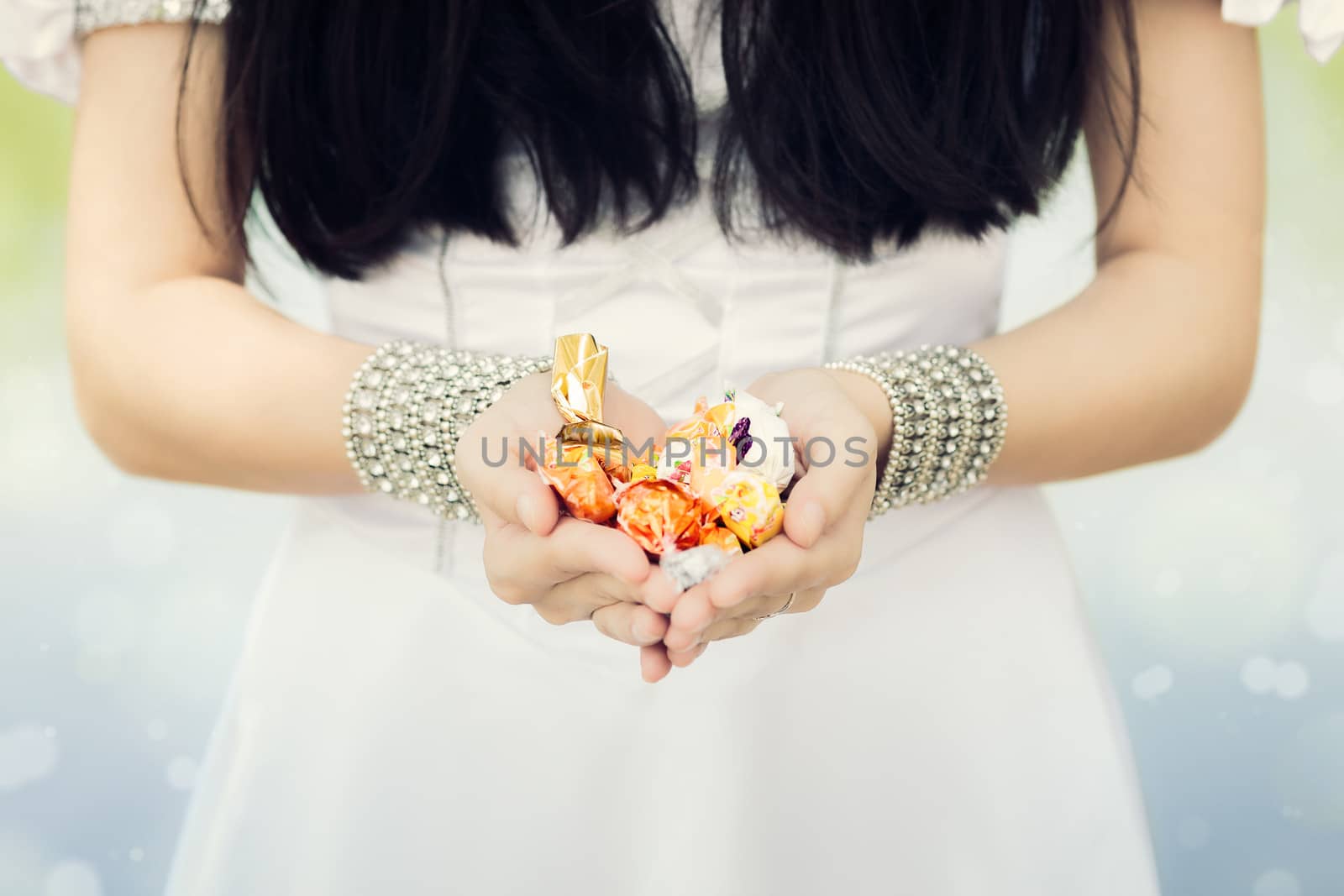 Girl's Hands Holding Candy by NicoletaIonescu