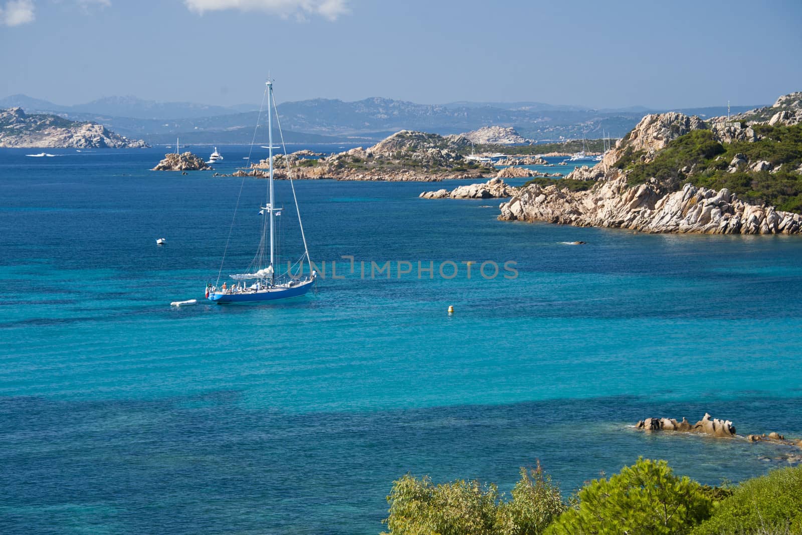 Boat sailing in the wonderful sea in Budelli , an island of the La Maddalena archipelago in Sardinia , Italy