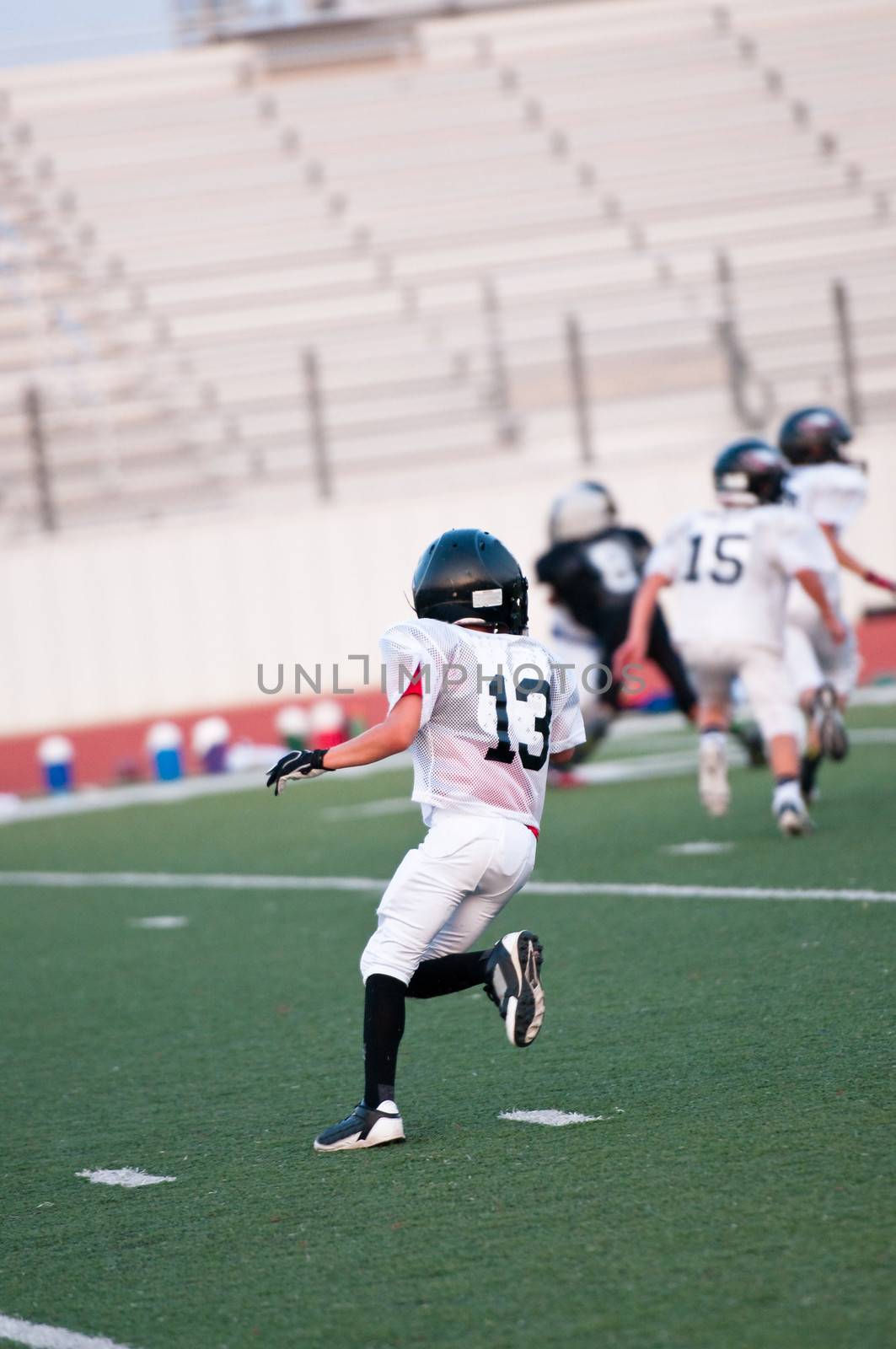 Youth football player as wide receiver going out for a pass.
