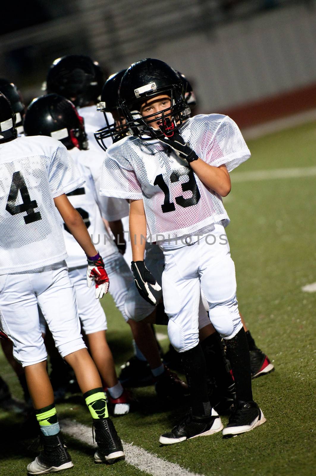 Young football boy looking at the coach.