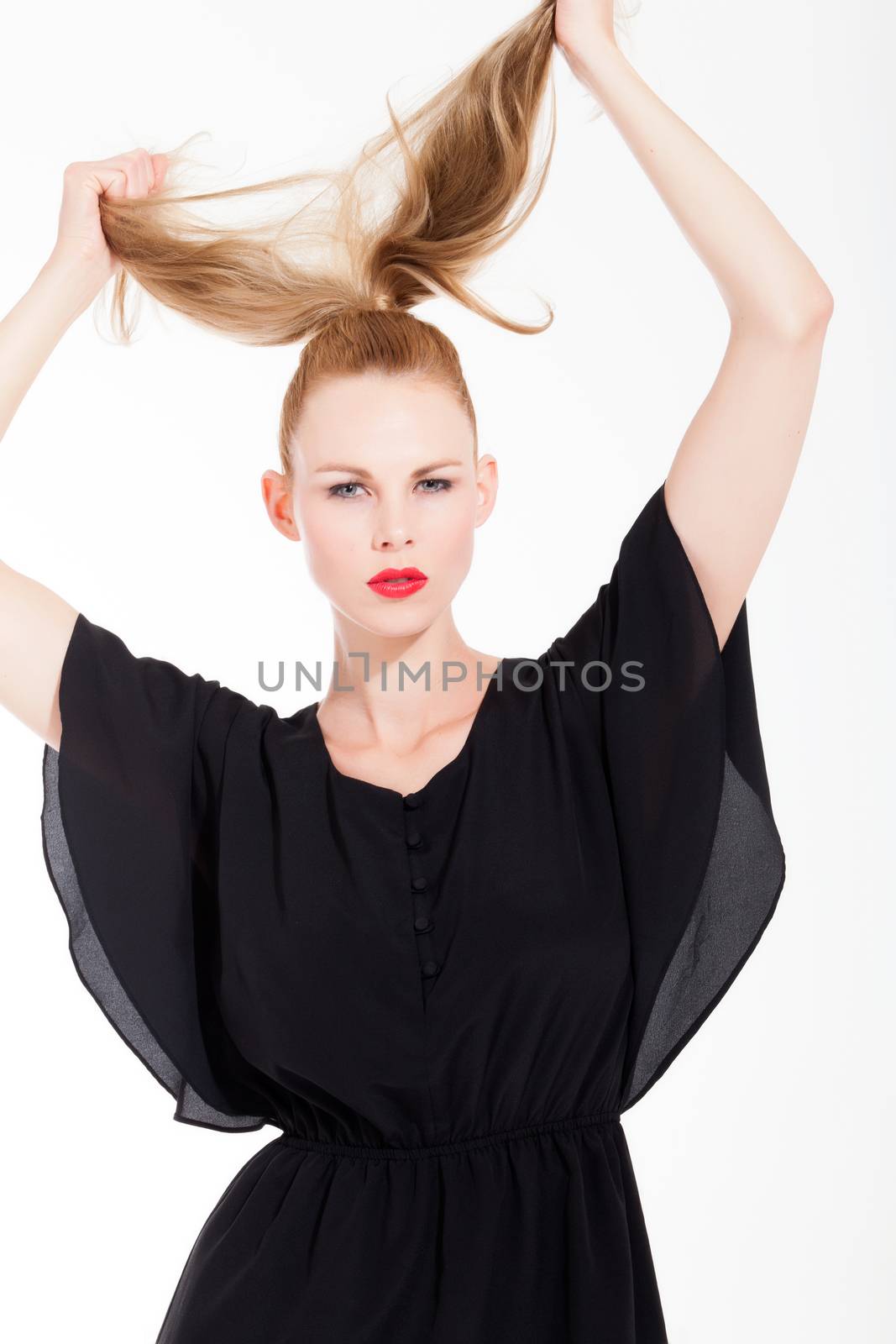 Beautifull young blond woman in the studio with a sexy black dress