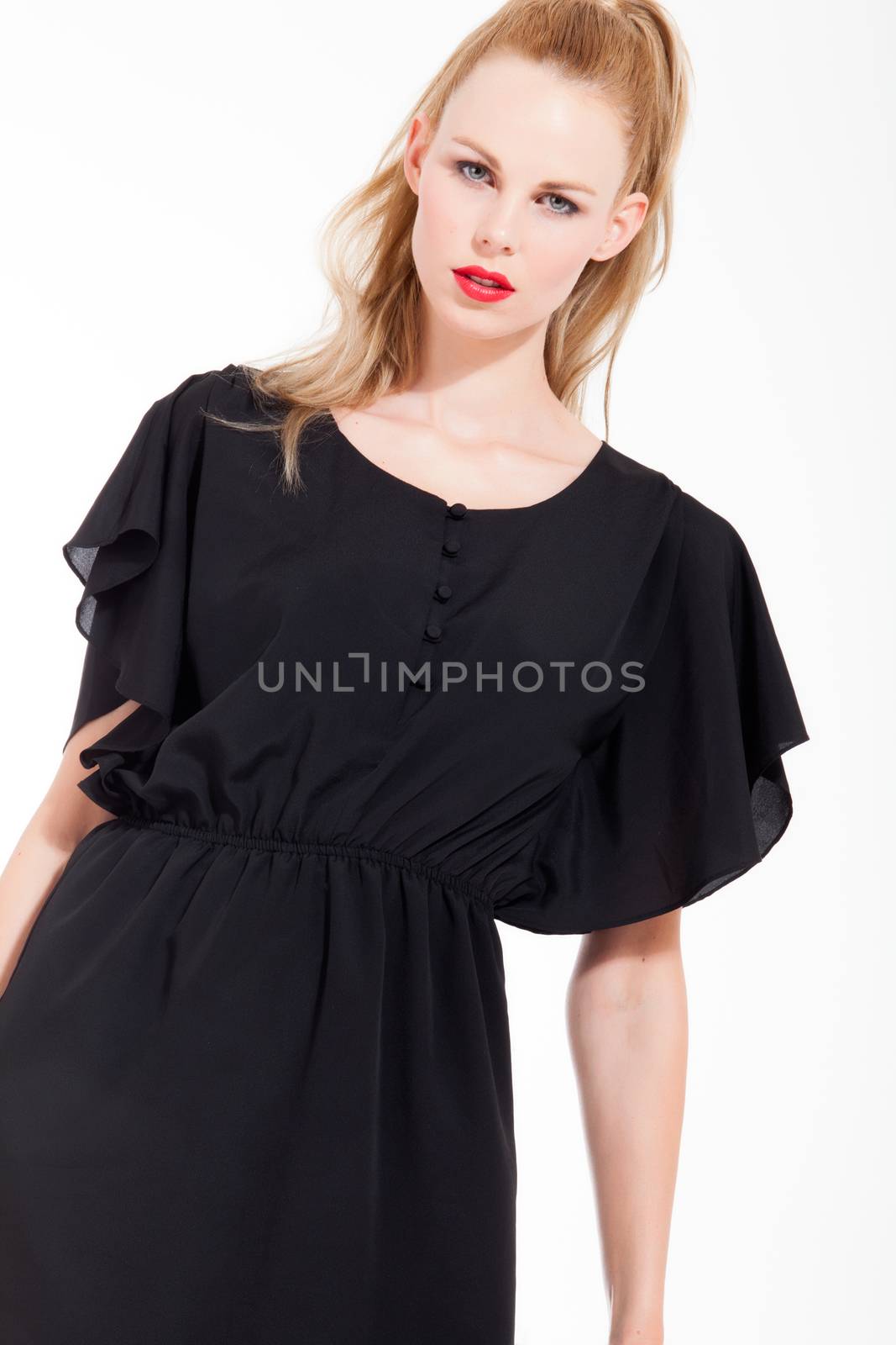 Beautifull young blond woman in the studio with a sexy black dress