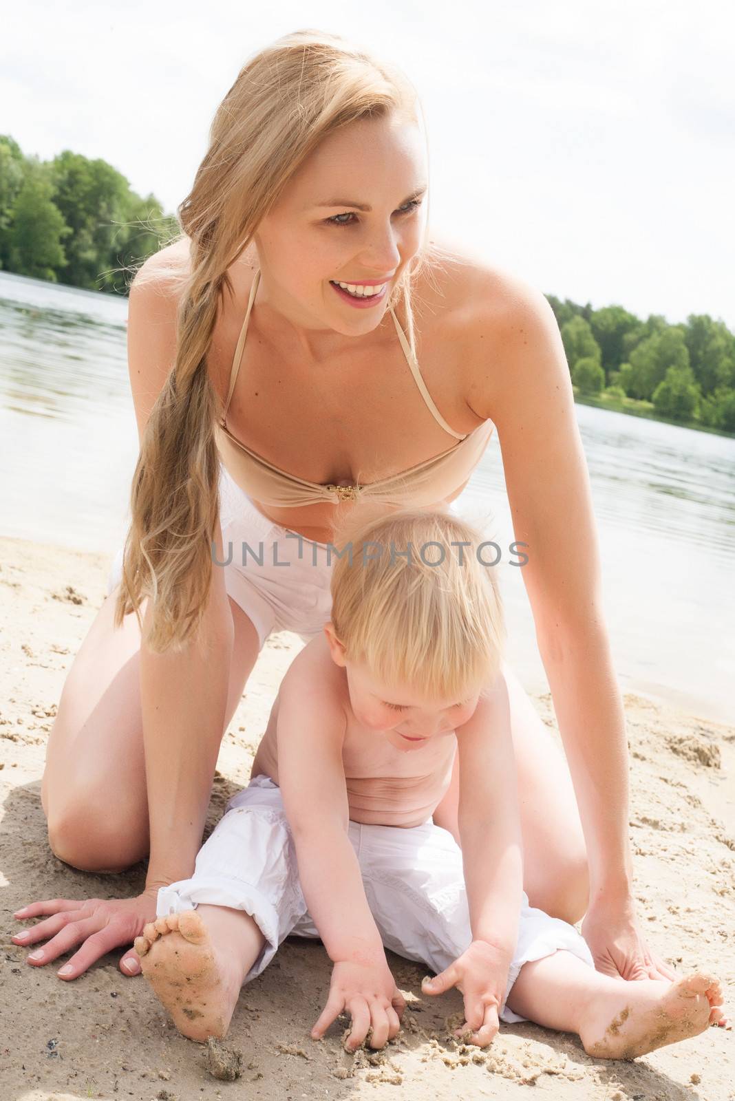 Mother and son writing in sand by DNFStyle