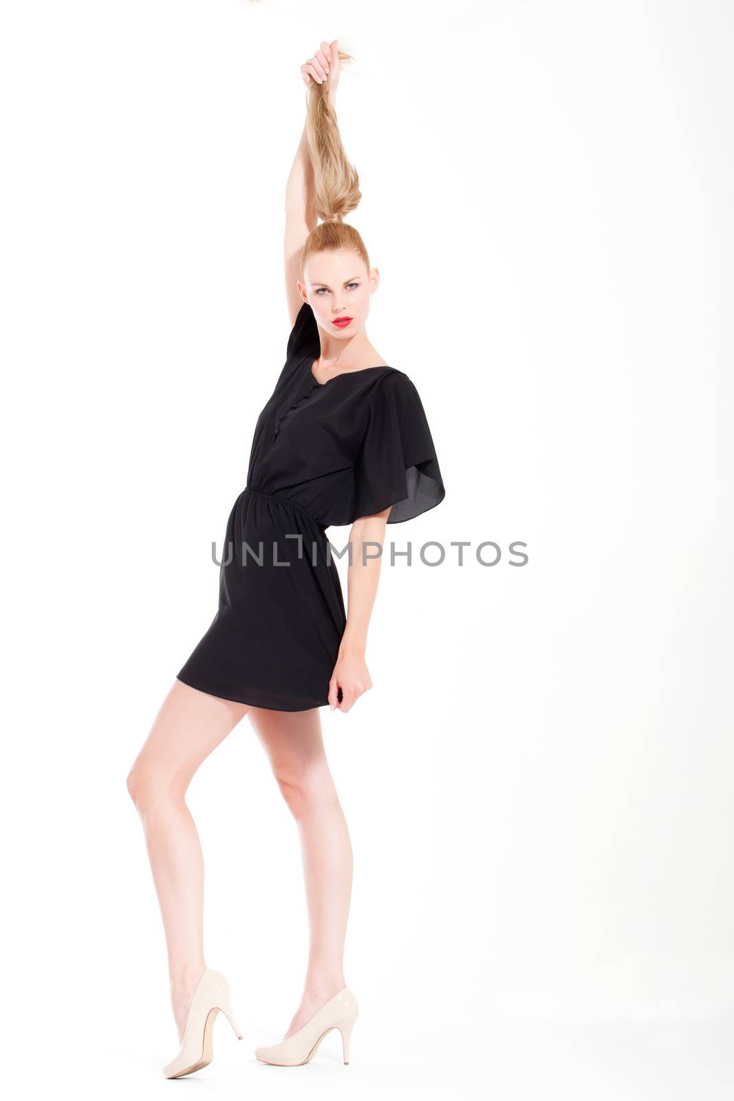 Beautifull young blond woman in the studio with a sexy black dress