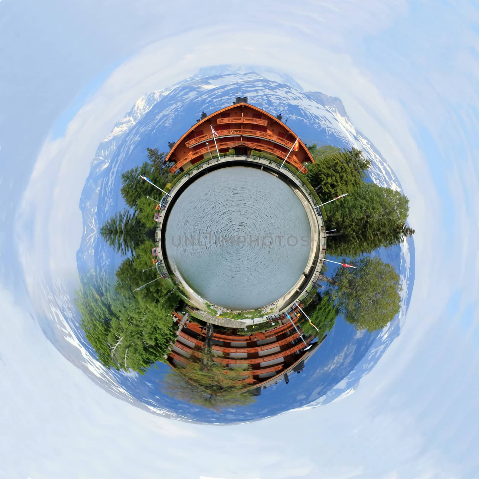 Planet with swiss chalet, Long lake and Alps mountains in summer, Crans Montana, Switzerland