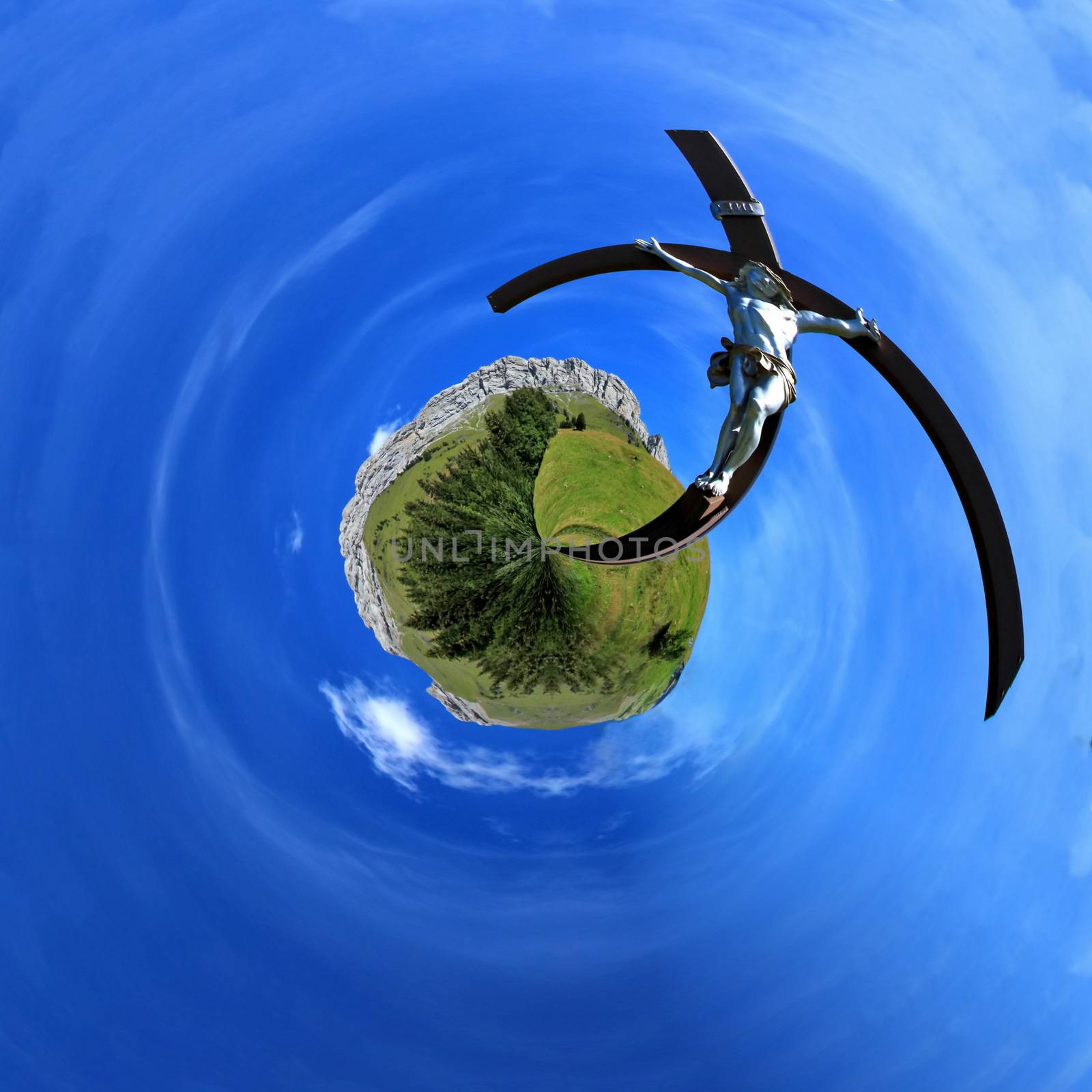 White sculpture of Jesus on a wood cross in the green mountain by summer planet