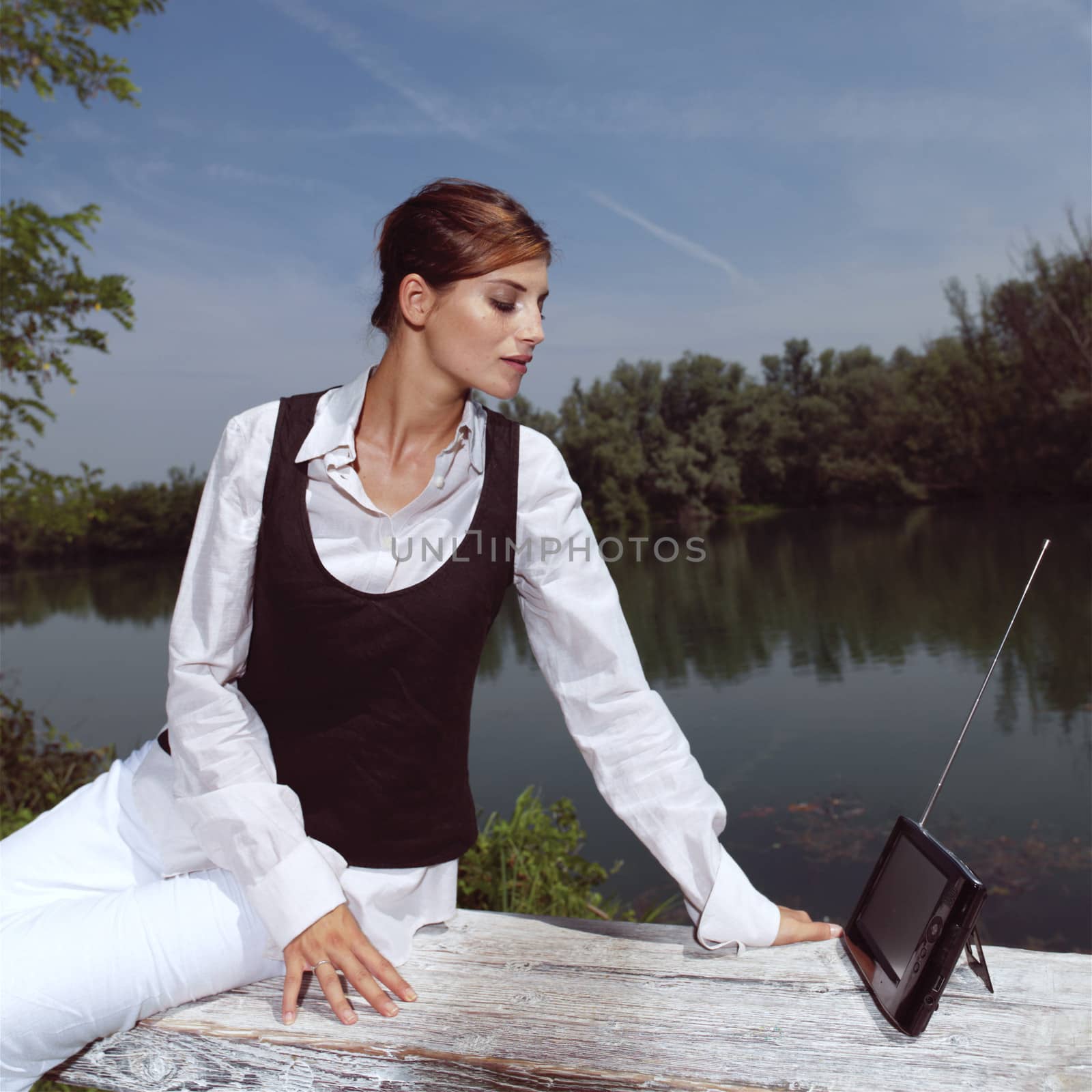 a woman with laptop in park by toocan