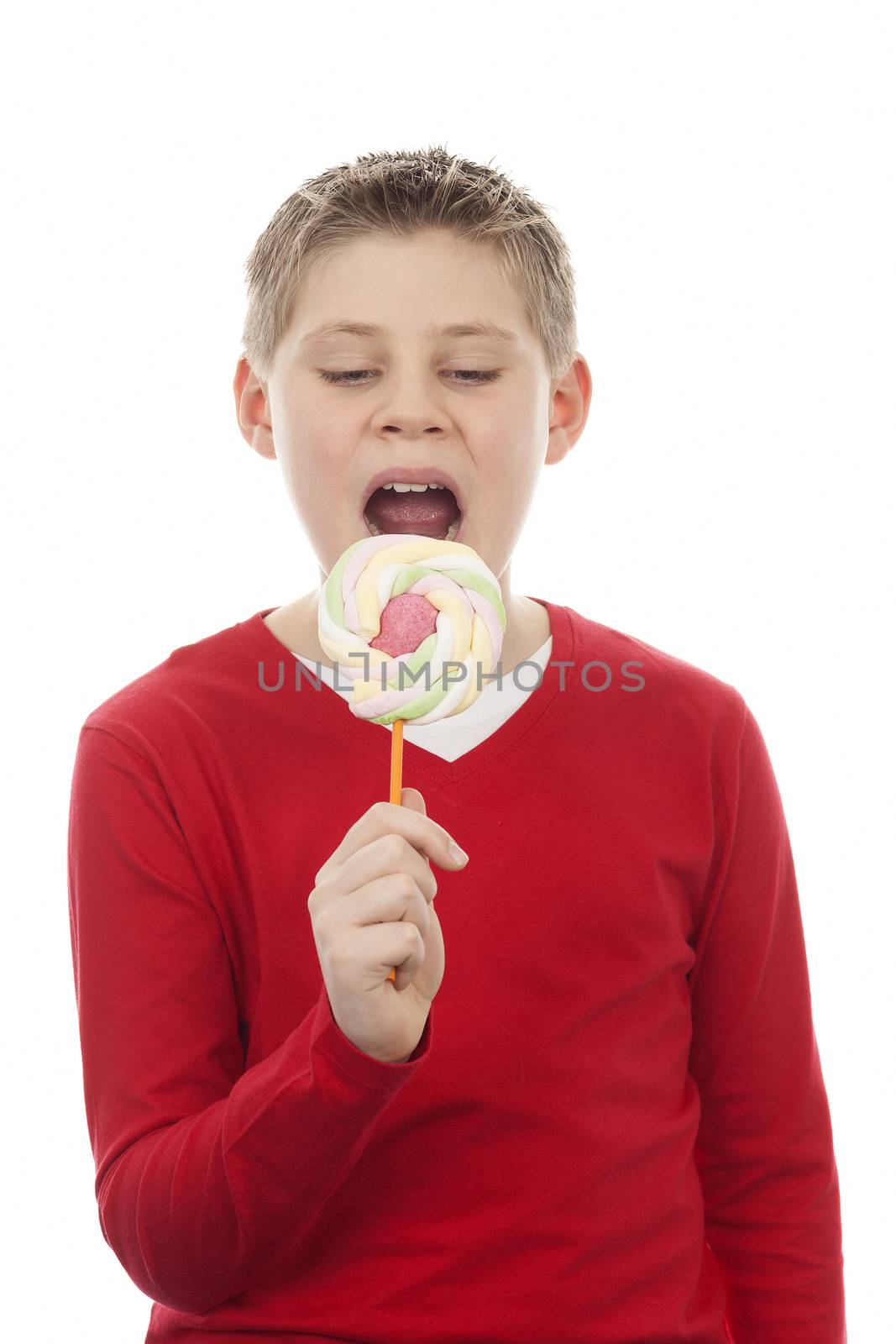Portrait of cute joyful boy with big lollipop