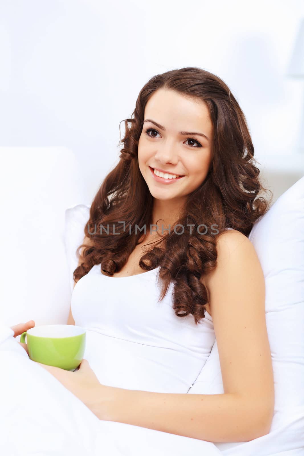 Portrait of lovely young woman having cup of tea at home