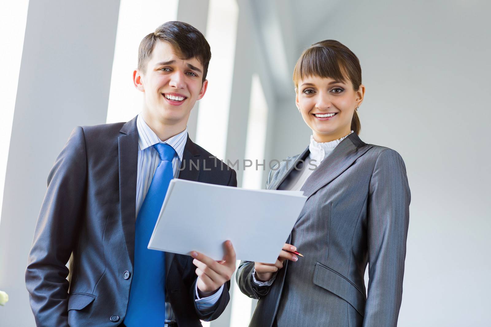 Young happy businessman and businesswoman people discussing project