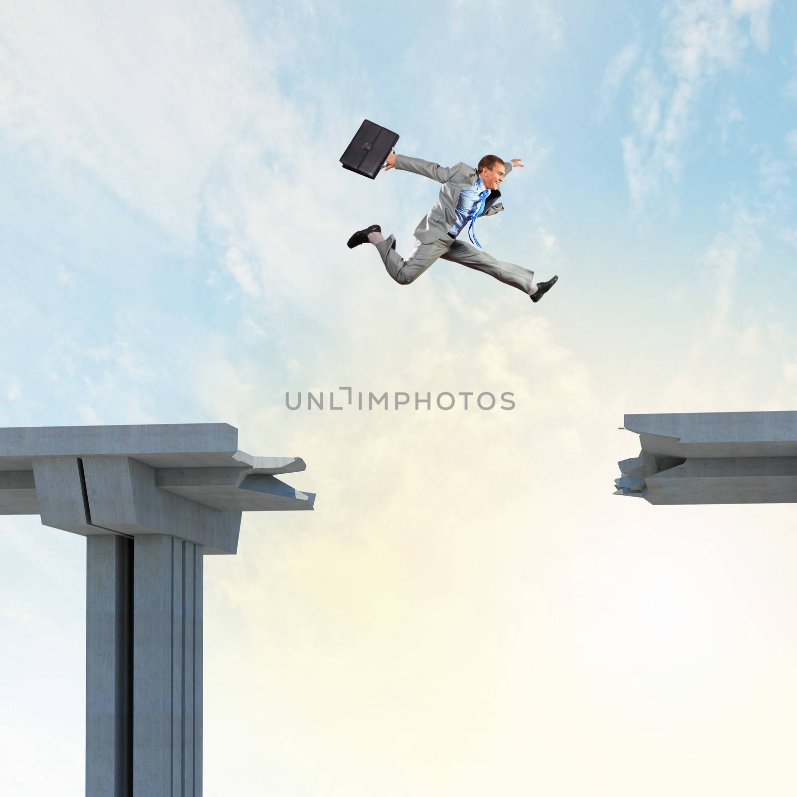Businessman jumping over a gap in the bridge as a symbol of bridge