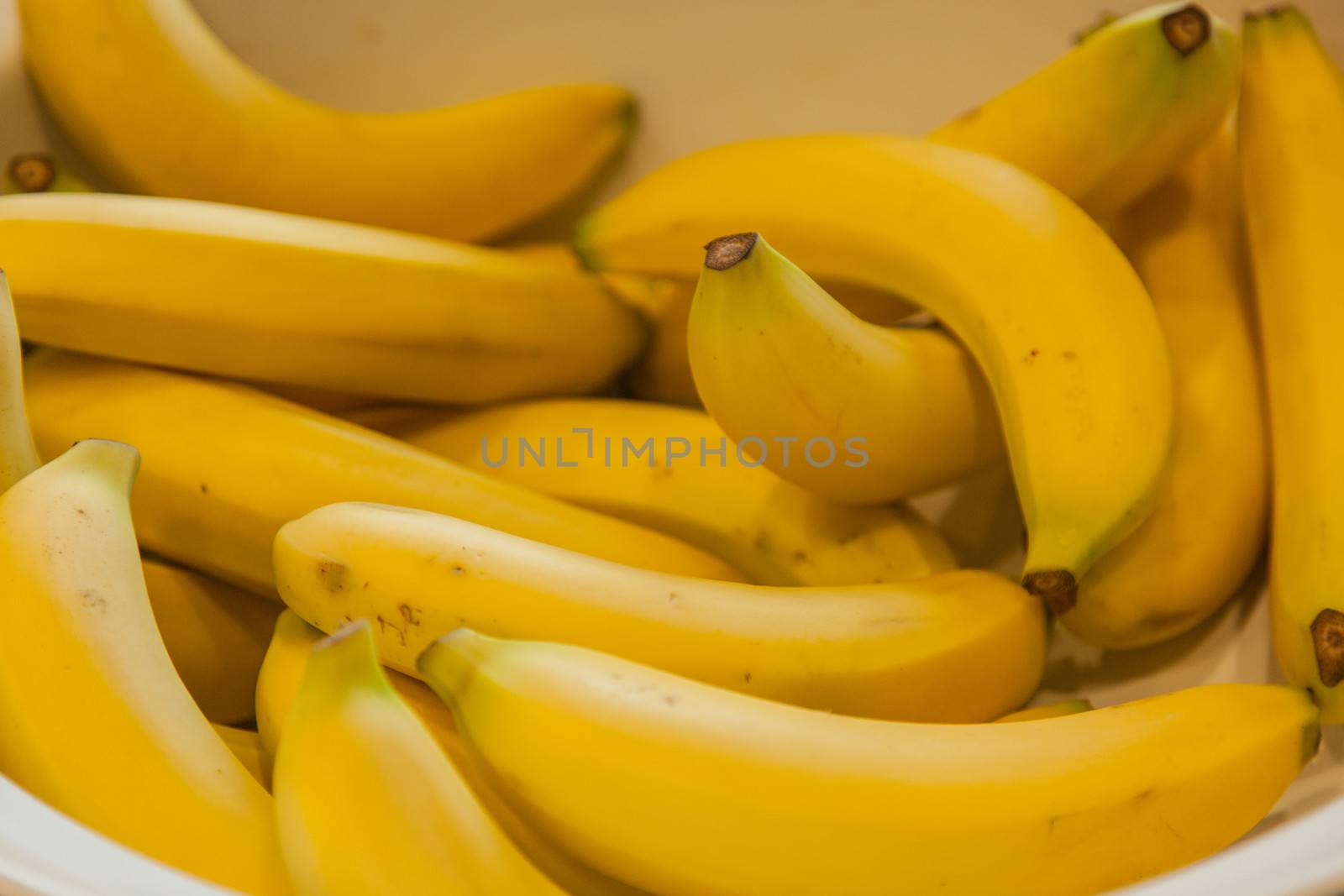 Banana is the common name for an edible fruit produced by several kinds of large herbaceous flowering plants of the genus Musa.