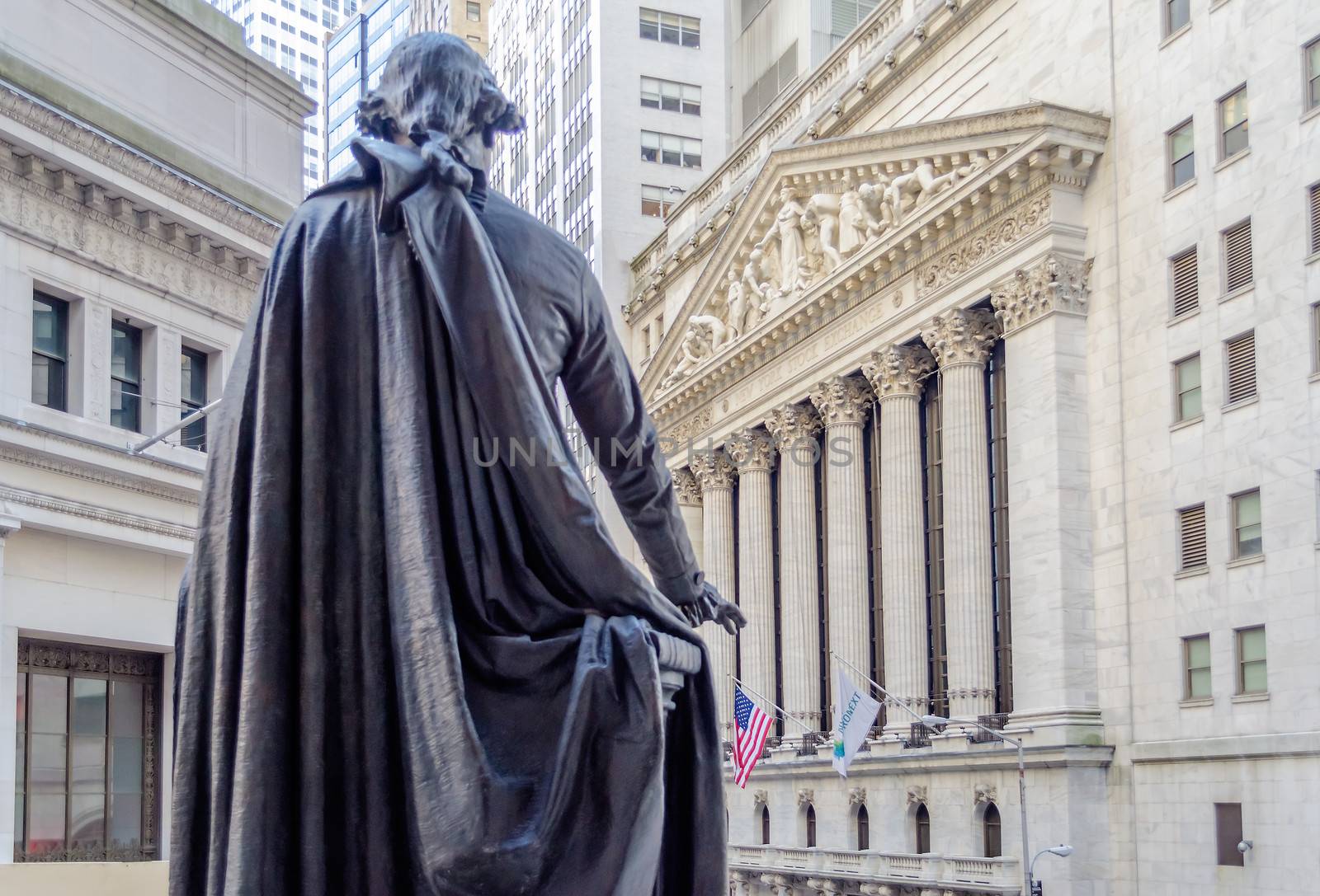 NEW YORK - MAY 27: The historic Wall Street facade from behind G.Washington statue in Federal Hall, May 27, 2013. Wall Street is the icon of global capitalism.
