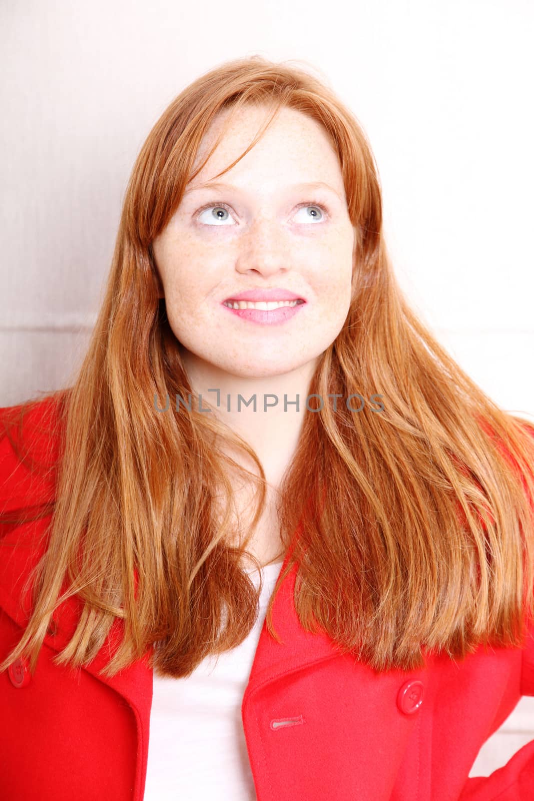 A attractive young, redhead  woman in Winter clothing.  