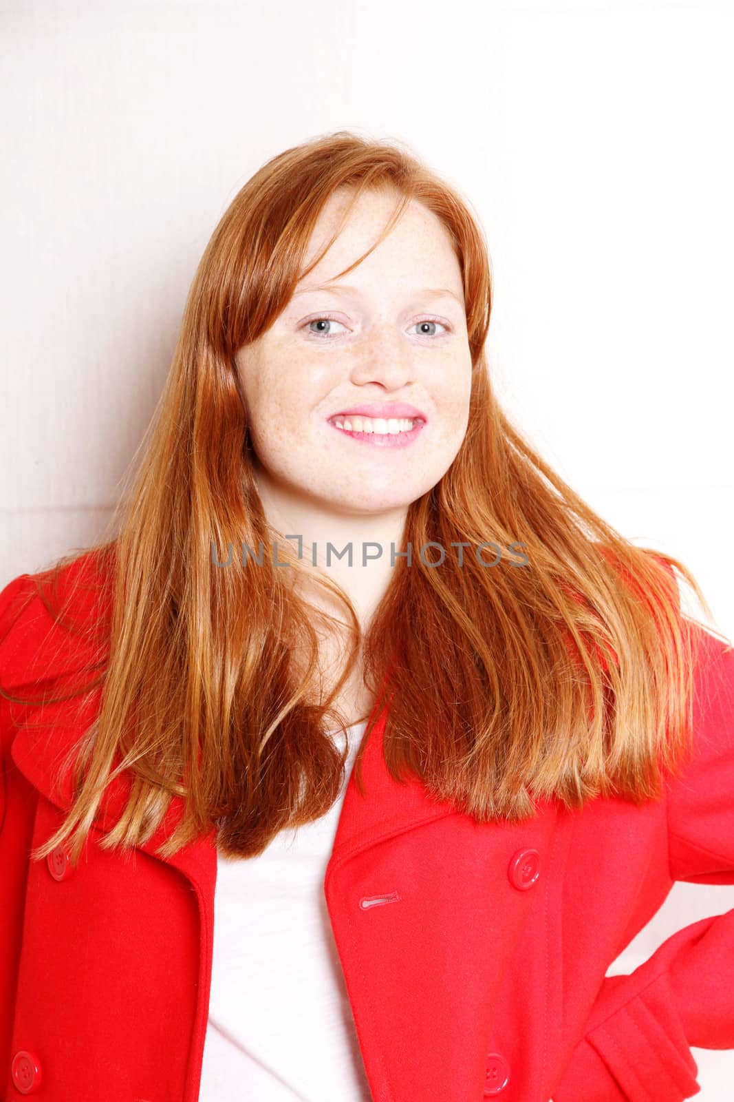 A attractive young, redhead  woman in Winter clothing.  