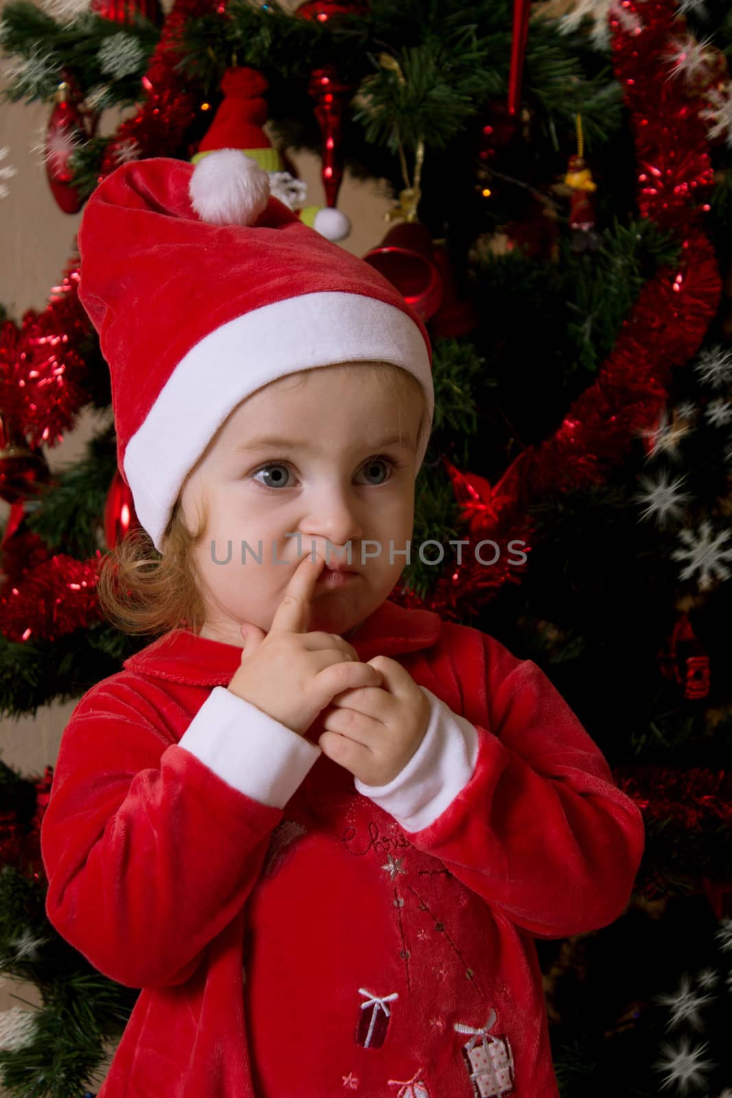 Little girl putting wishes under Christmas tree by Angel_a