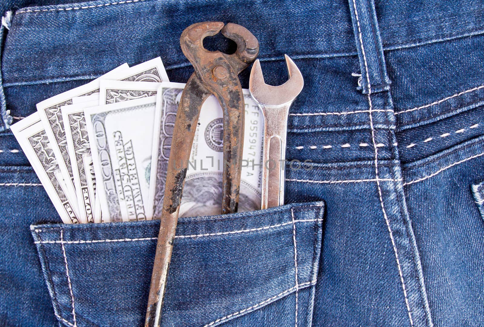 American dollar bills and tools in jeans pocket background