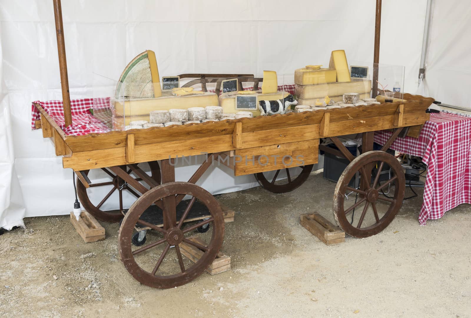 wooden car with cheese for sale on the market