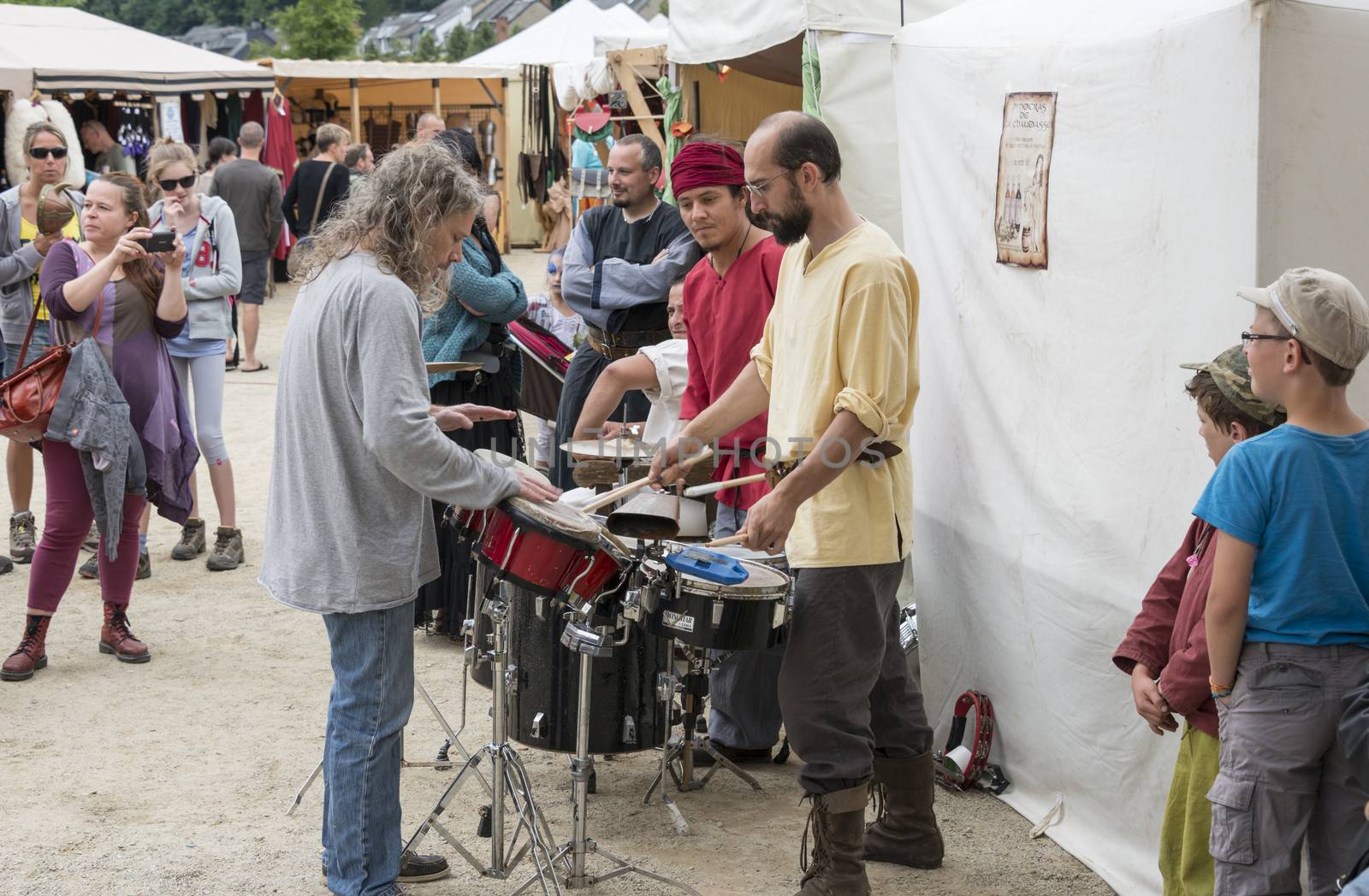 people playing music on the market in the belgium city bouillon