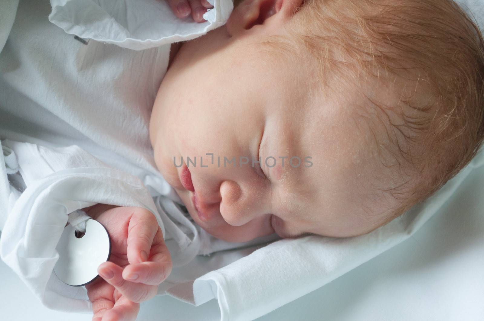 Closeup of Sleeping Newborn Baby in Swaddling Blanket