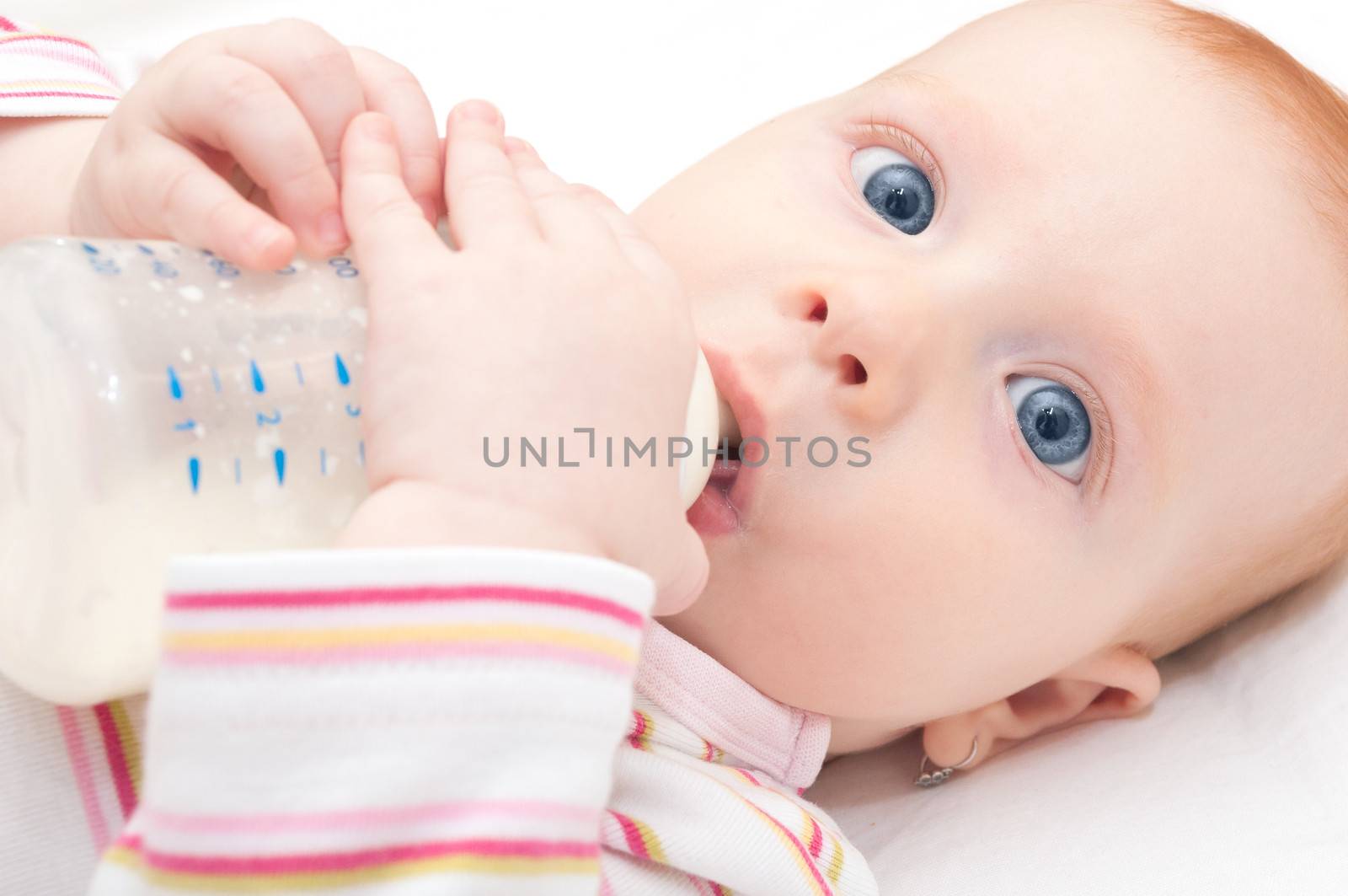 Closeup of Baby Girl Drinking Milk from Bottle - Shallow Depth of Field