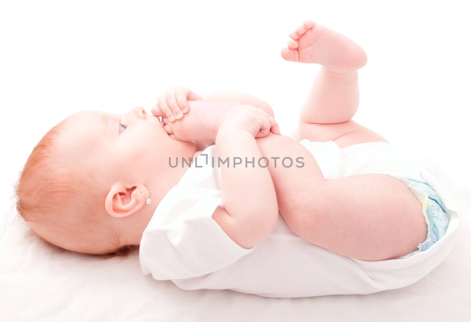Cute Baby Girl Sucking Her Toes on White Background