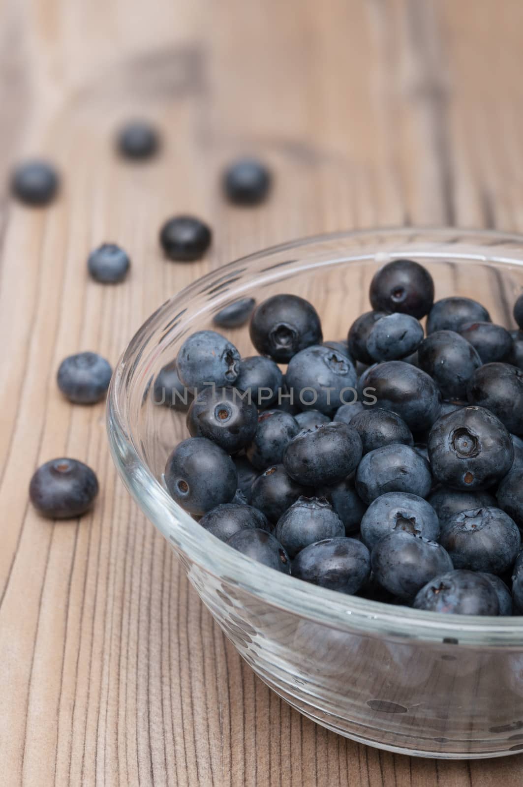 Glass Bowl of Ripe Blueberries on Wooden Table - Shallow Depth of Field