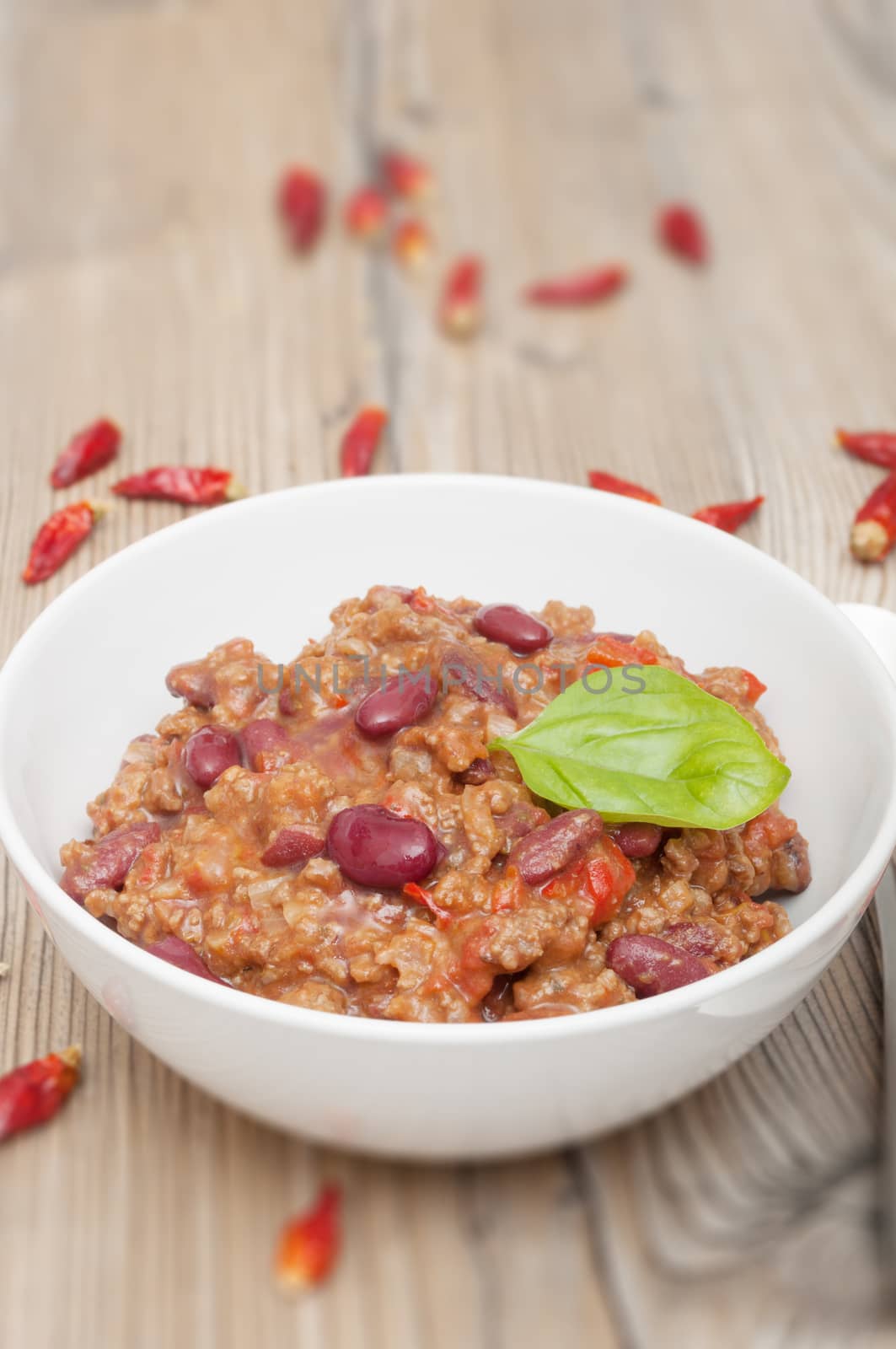Chilli Con Carne in White Bowl and Red Chili Peppers - Shallow Depth of Field