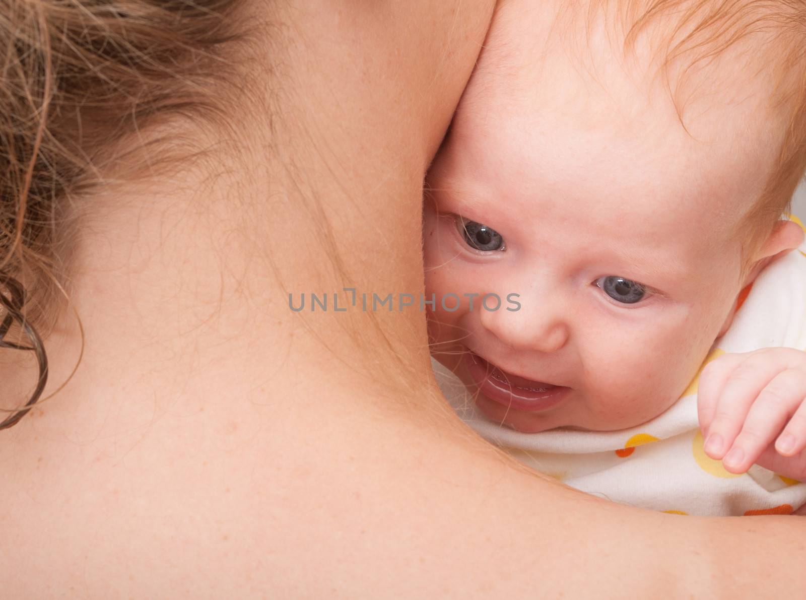 Mother from Behind Holding  Newborn Baby