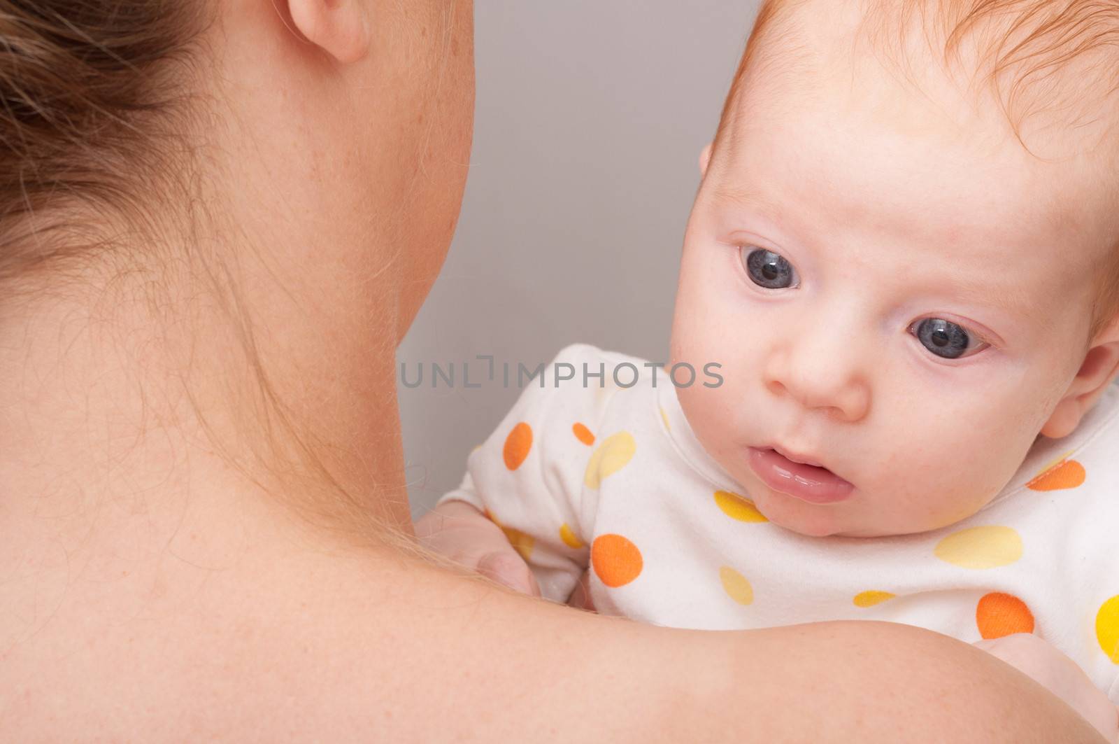 Mother from Behind Holding Newborn Baby