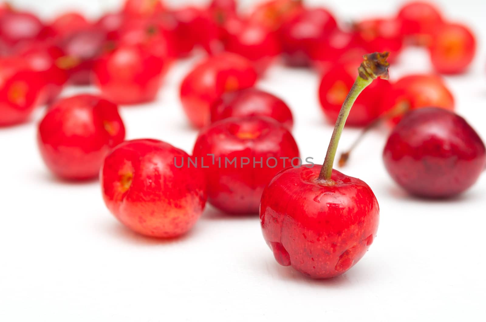 Fresh Red Cherries on White Wooden Table - Shallow Depth of Field