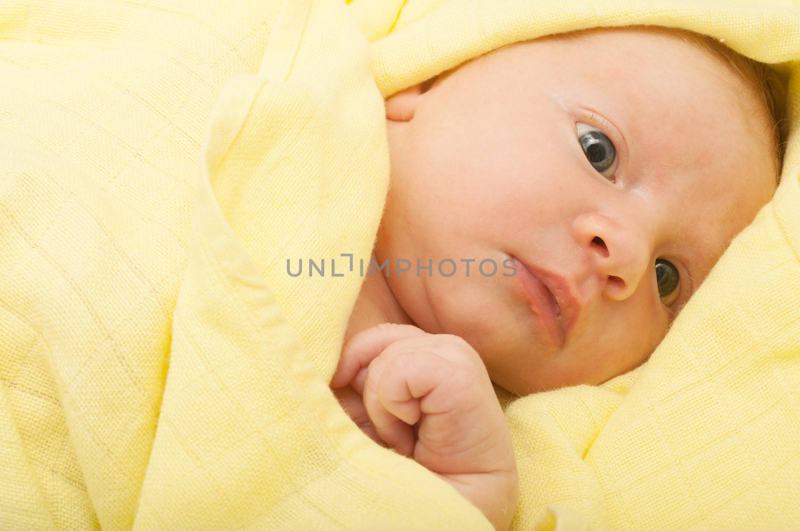 Newborn Baby in the Bed under Yellow Blanket