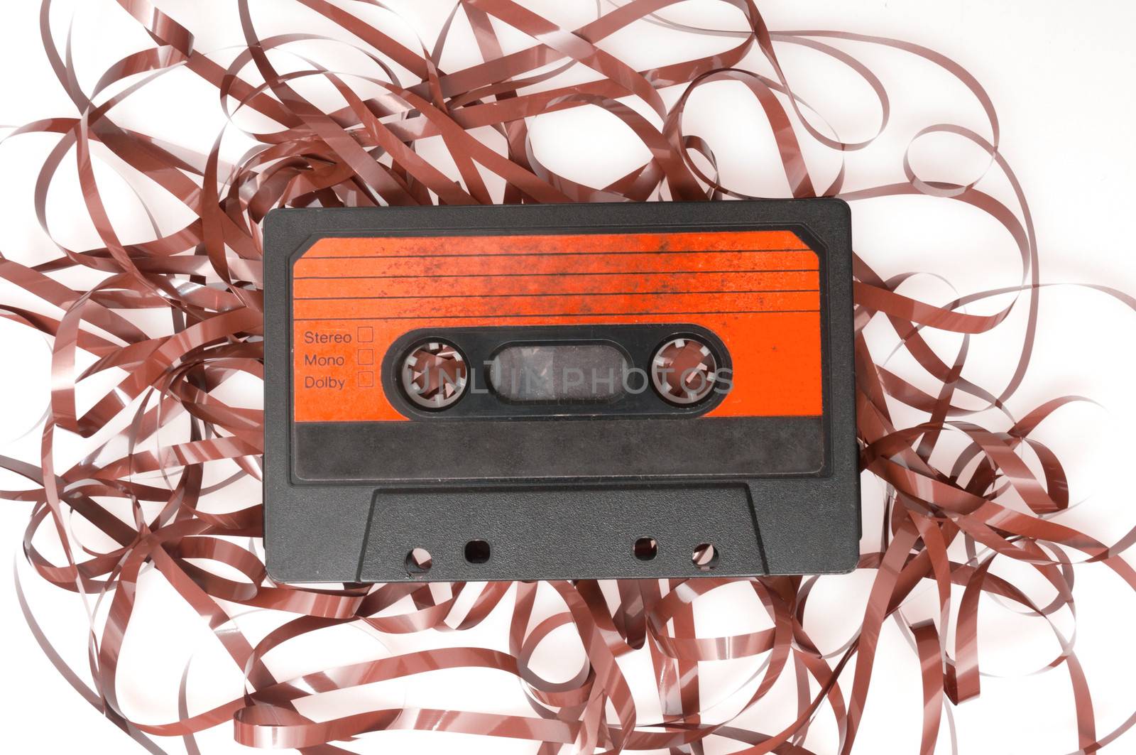 Retro Audio Cassette Tape With Pulled Out Tape on White Background