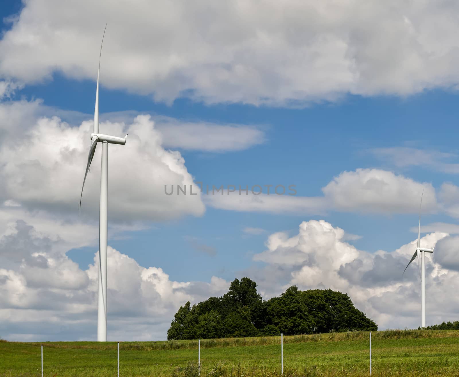 three-bladed wind generator with a horizontal axis of rotation on sky background