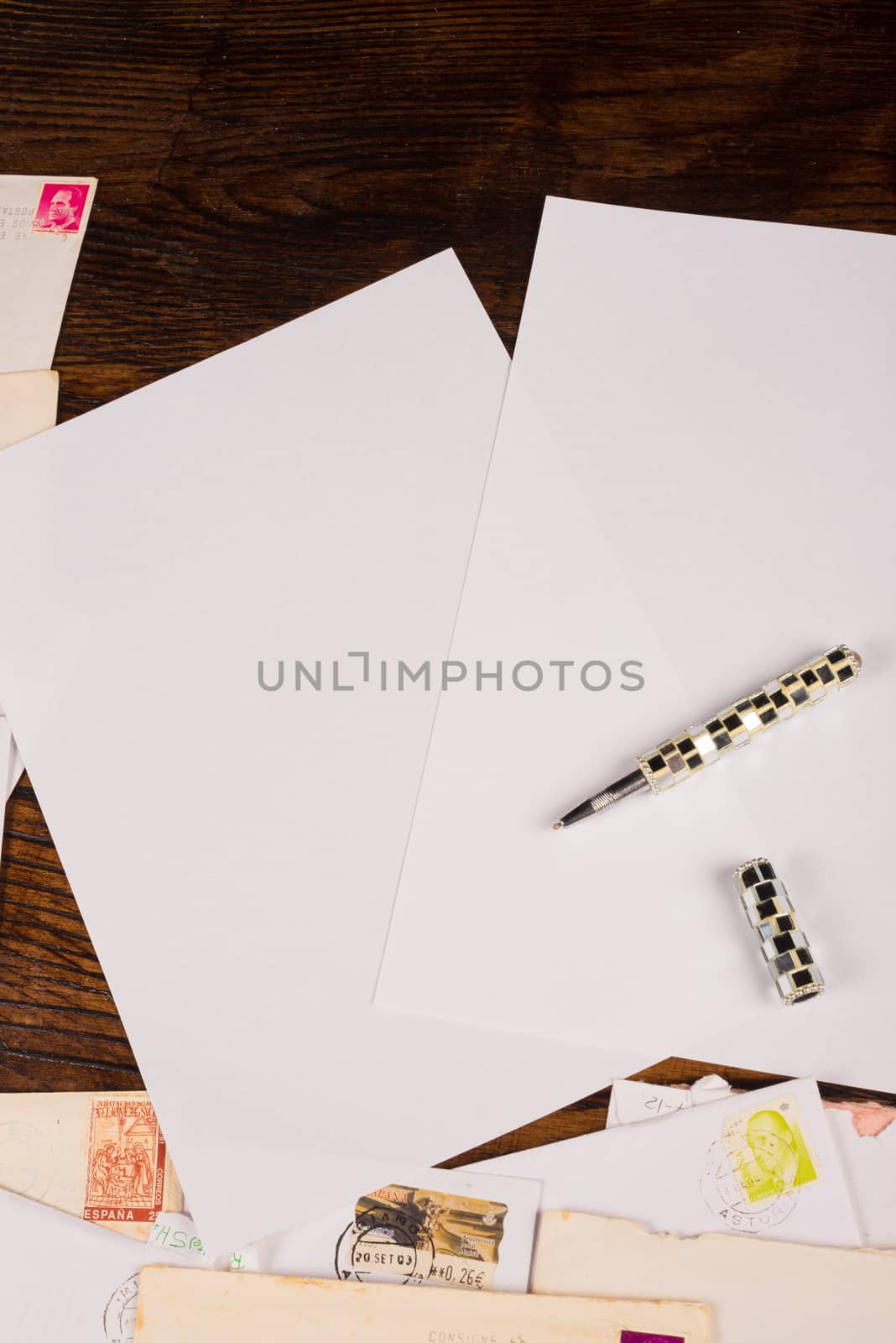 A stack of letters and white writing paper, a background