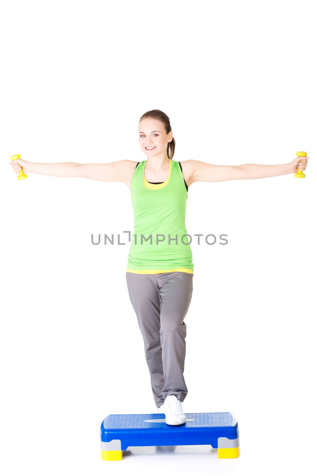 Fitness girl is working out with stepper , isolated on white background