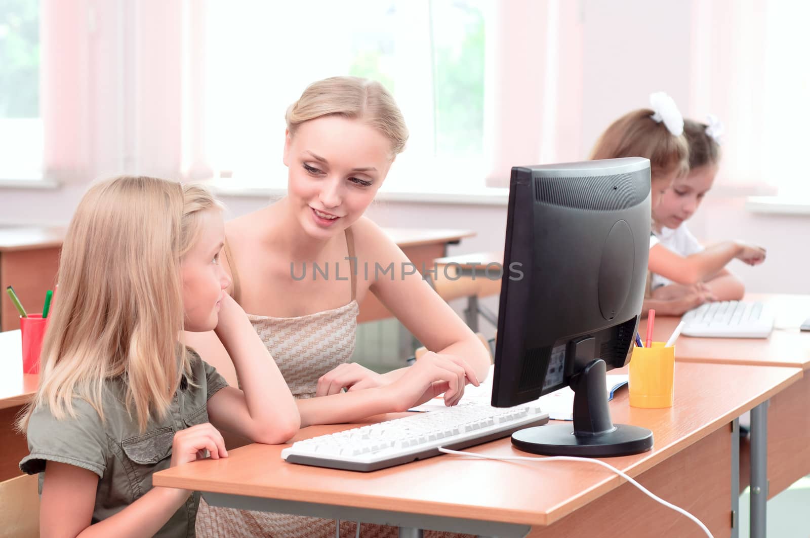 teacher explains the task schoolgirl at the computer, the new technologies in education