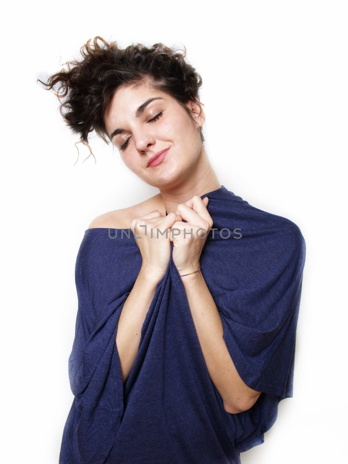 Young woman in blue t-shirt hugging herself