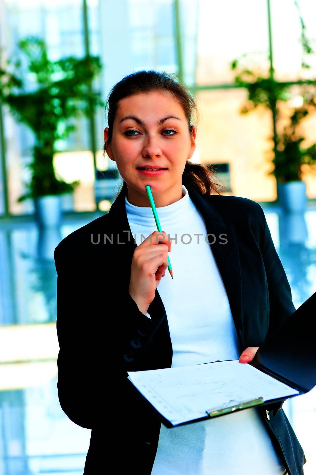 Young brunette woman in business suit pondered over the offer