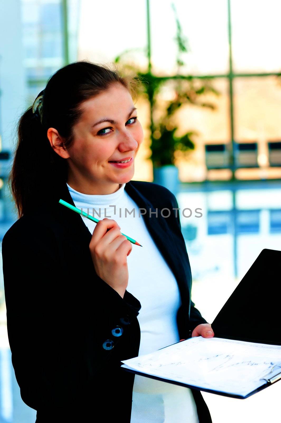 Coquettishly smiling businessman holding an open folder in his hands itself