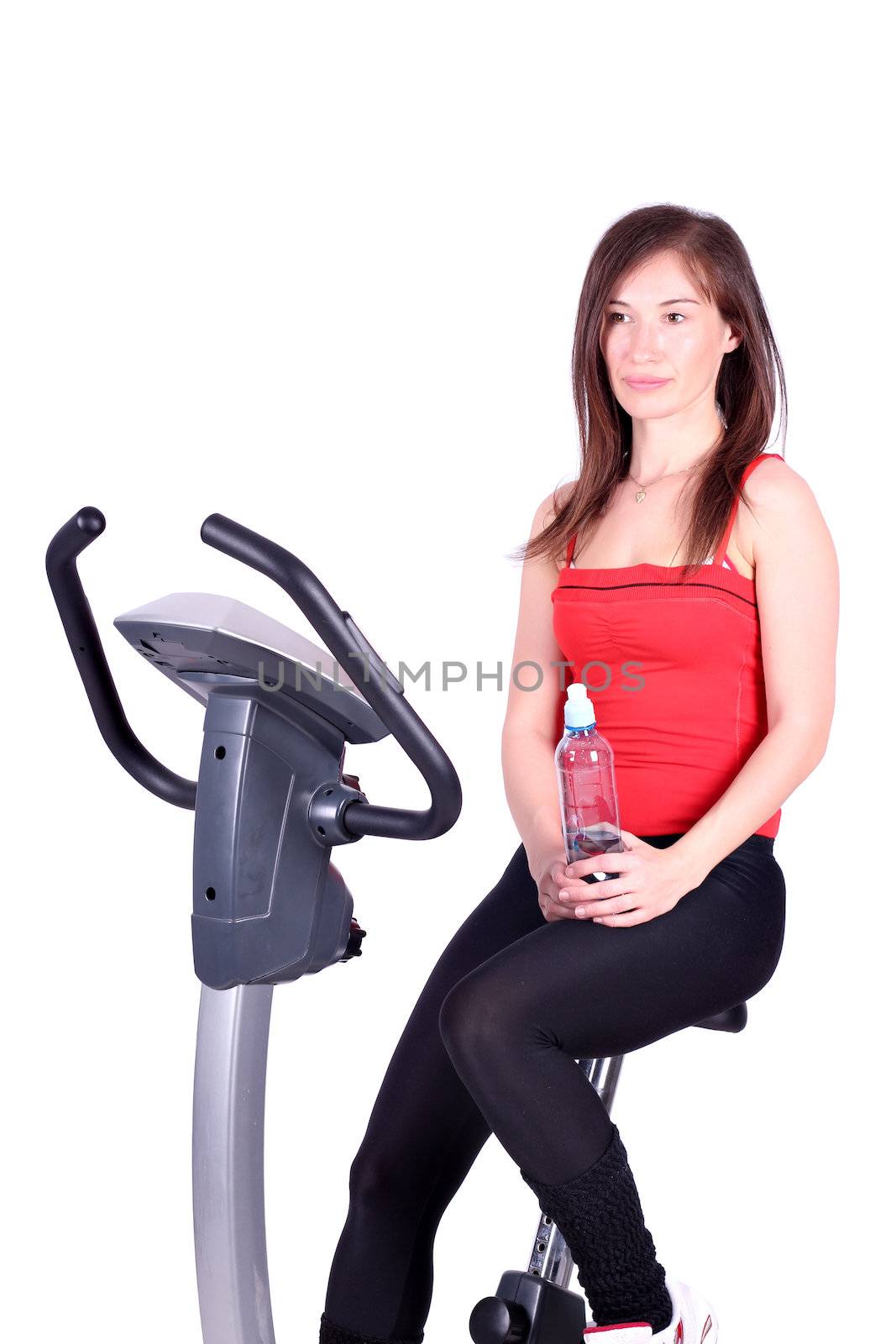 girl with bottle of water sitting on cross trainer by goce