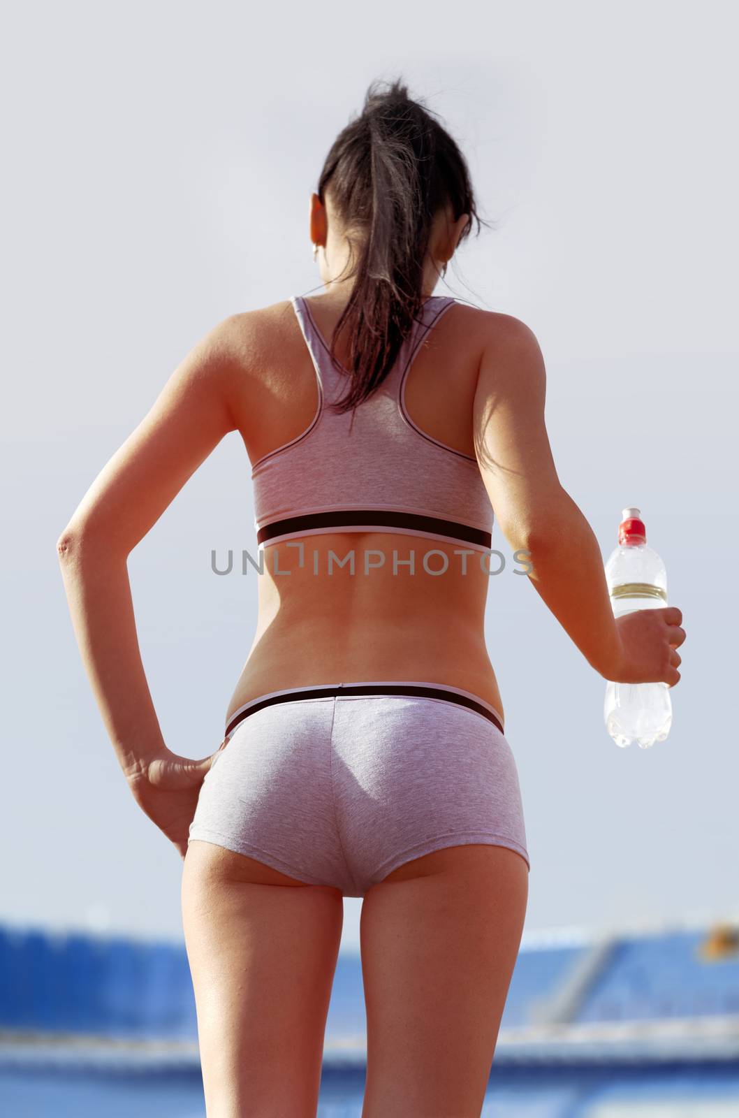 back of woman with bottle by ssuaphoto