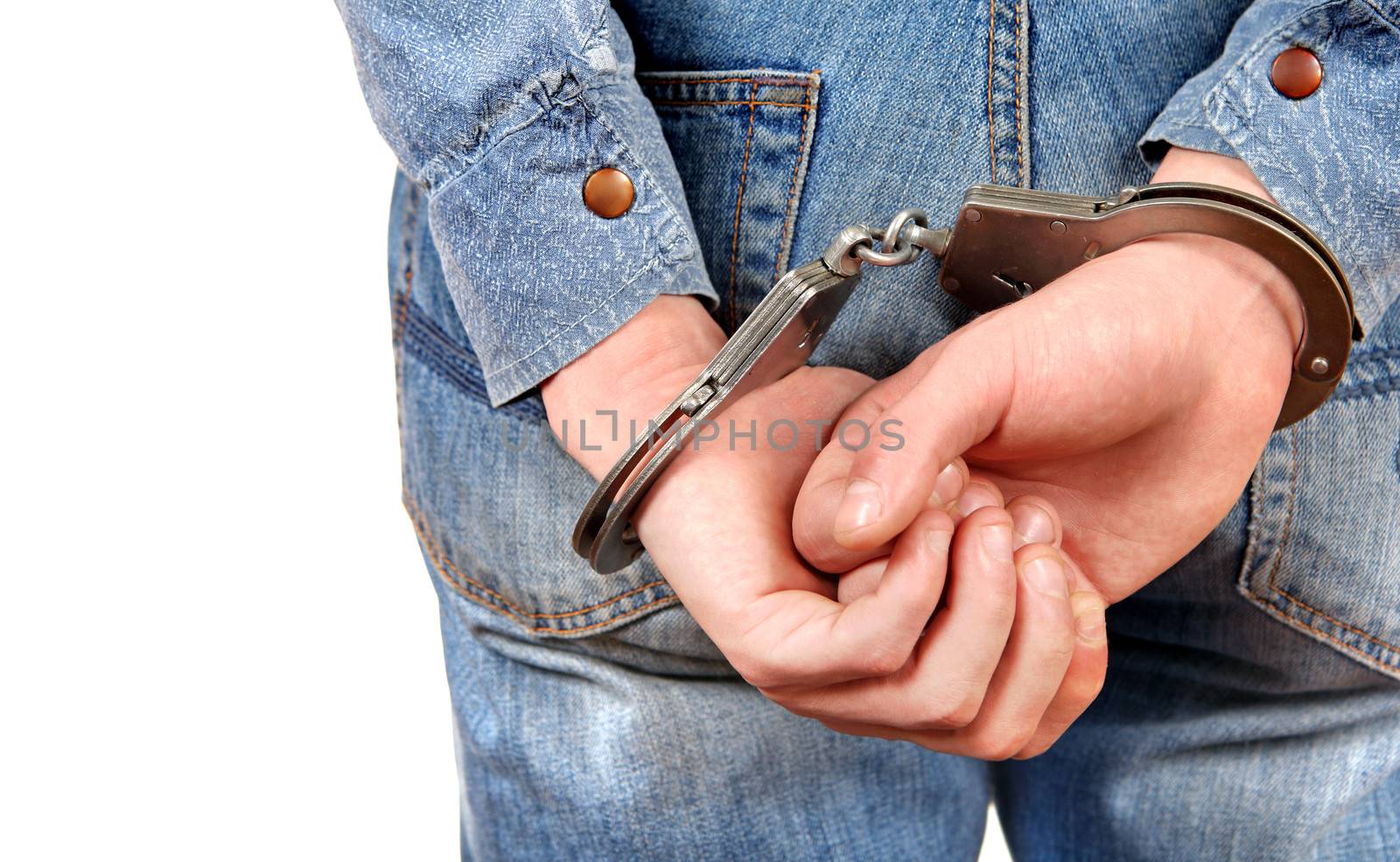 Rear view of the Man in Handcuffs on the White Background Closeup