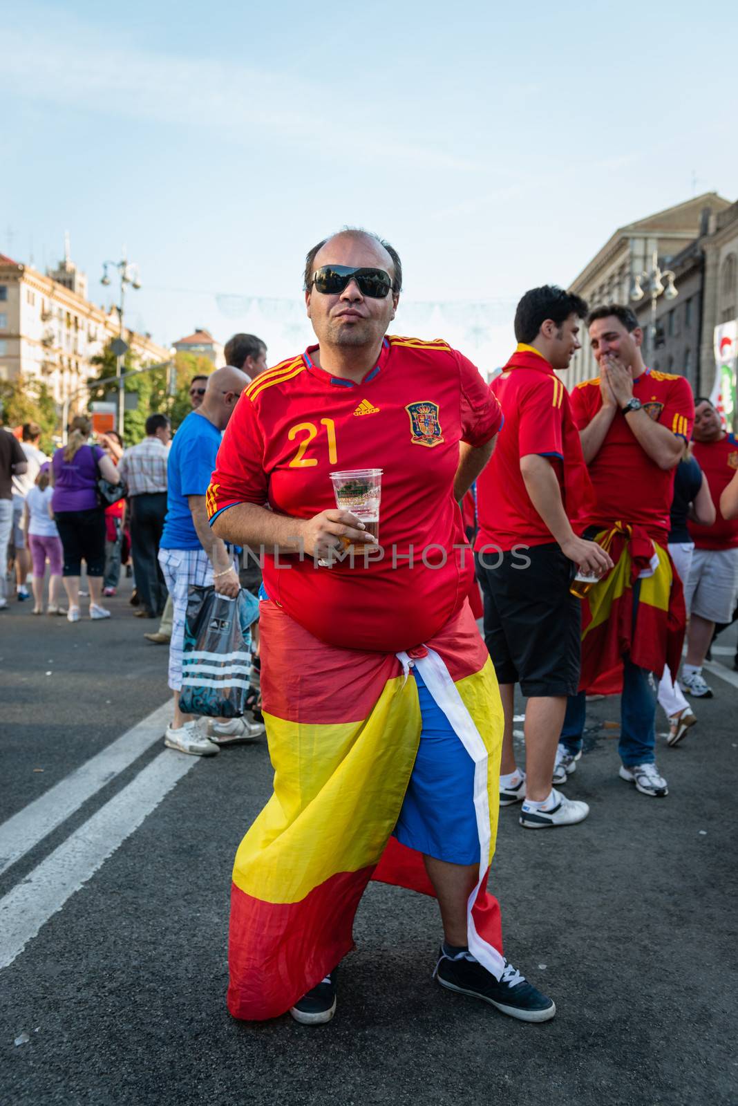 KIEV, UKRAINE - JUL 1: Spanish football fan drink beer on the central fun zone before EURO 2012 final match Spain vs. Italy on July 1, 2012 in Kiev, Ukraine
