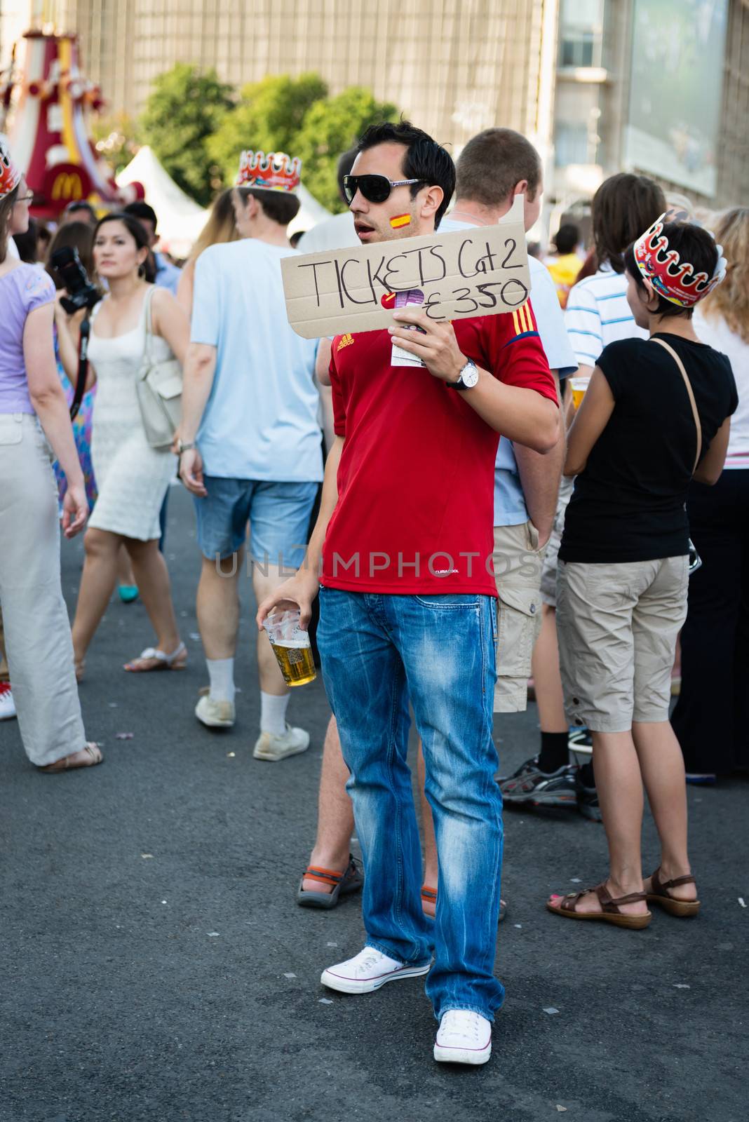 KIEV, UKRAINE - JUL 1: Man on the central fan zone sells tickets before EURO 2012 final match Spain vs. Italy on July 1, 2012 in Kiev, Ukraine