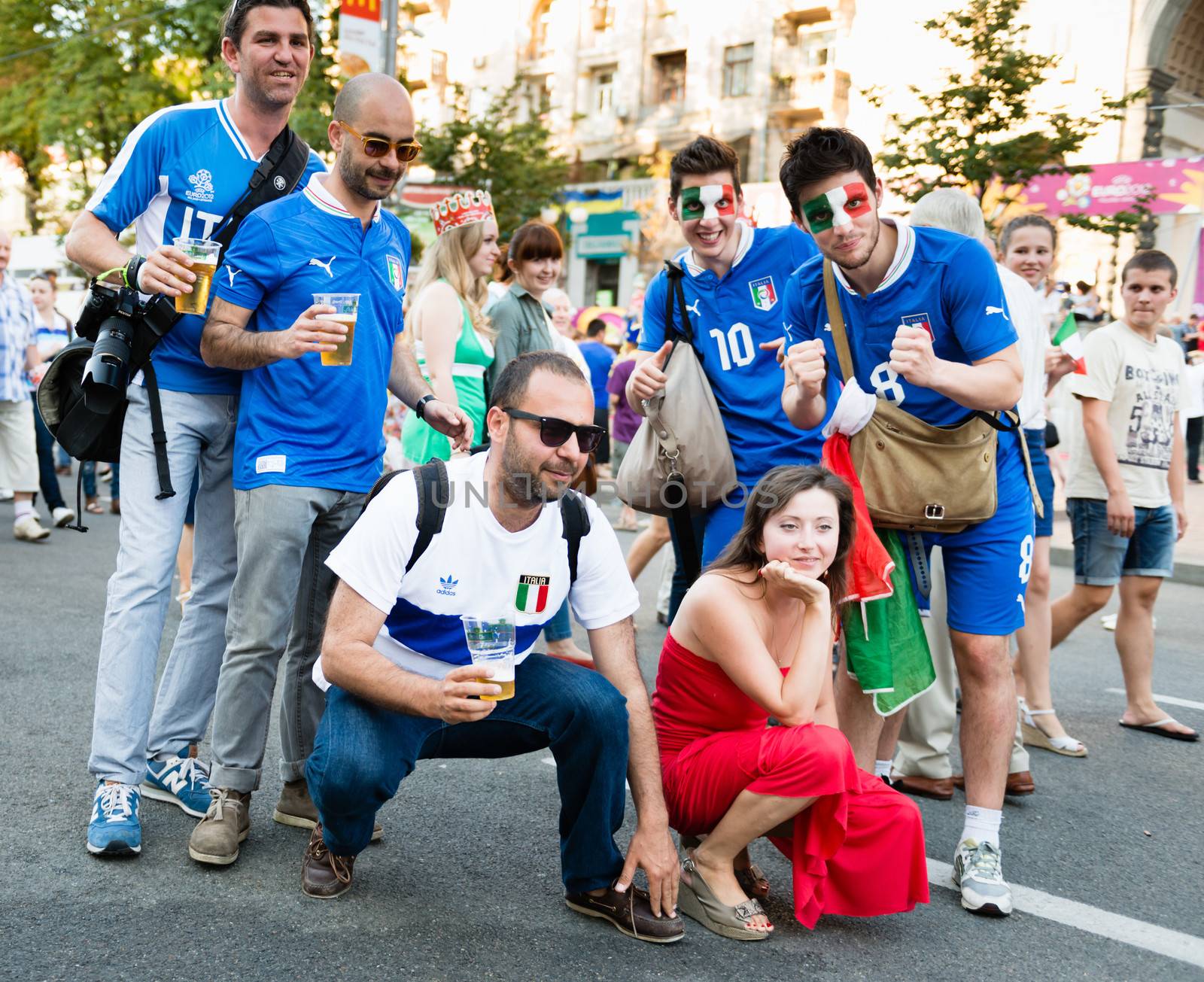 KIEV, UKRAINE - JUL 1: Italian football fans are photographed with Ukrainian girl before EURO 2012 final match Spain vs. Italy on July 1, 2012 in Kiev, Ukraine