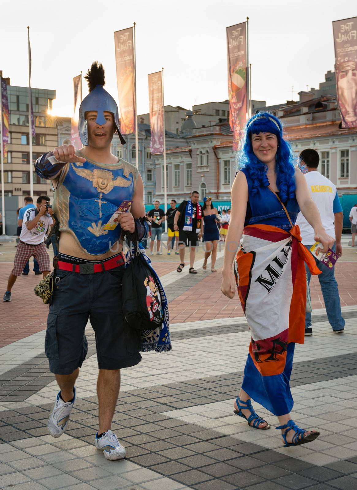 KIEV, UKRAINE - JUL 1: Couple of Italian football fans in costumes go to EURO 2012 final match Spain vs. Italy on July 1, 2012 in Kiev, Ukraine